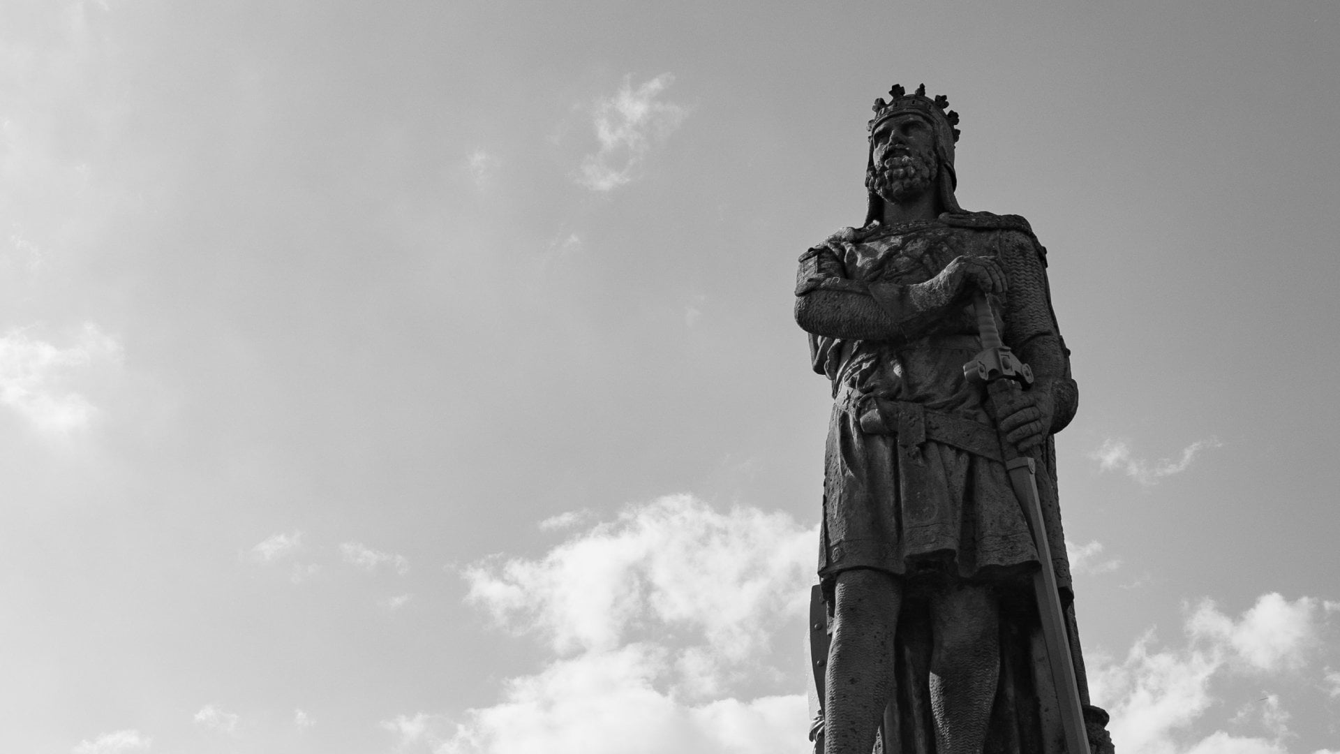 Scotland, UK Low angle shot of the statue of Robert the Bruce under a cloudy sky in grayscale