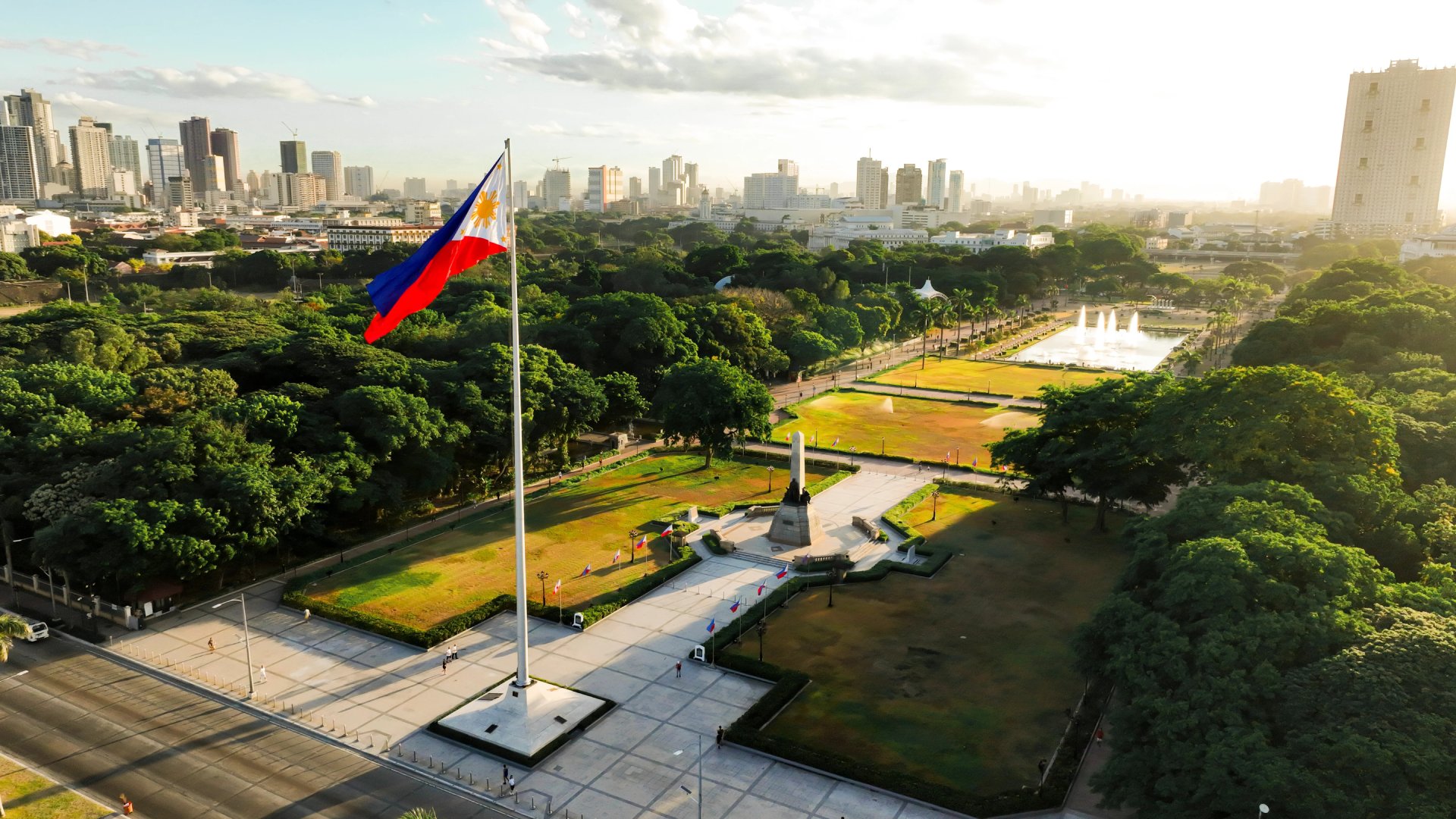 Overhead view of the Philippines flag waving over Luneta Park during a sunny day in Manila, Philippines