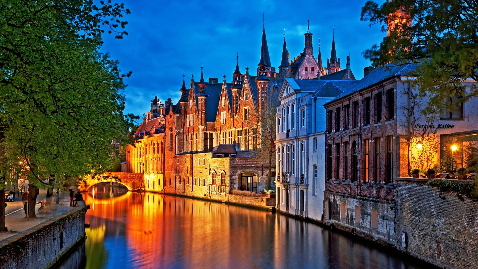Night shot of historic medieval buildings along a canal in Bruges, Belgium