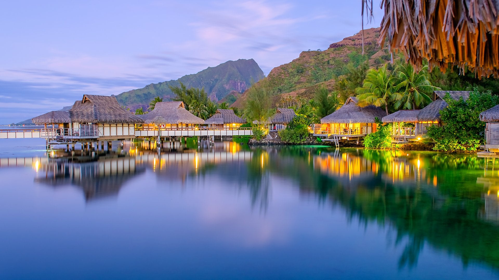 Overwater bungalows at dusk, Tahiti Vacations
