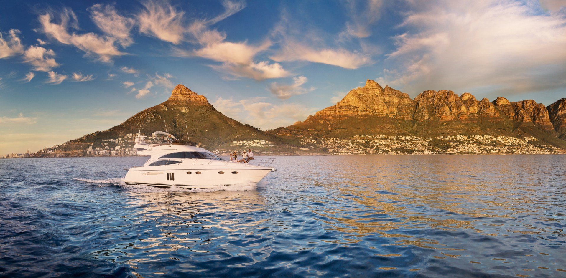 Camps Bay, South Africa (South African Tourism) A yacht cruises along the coast near the Twelve Apostles in Camps Bay in South Africa's Western Cape.