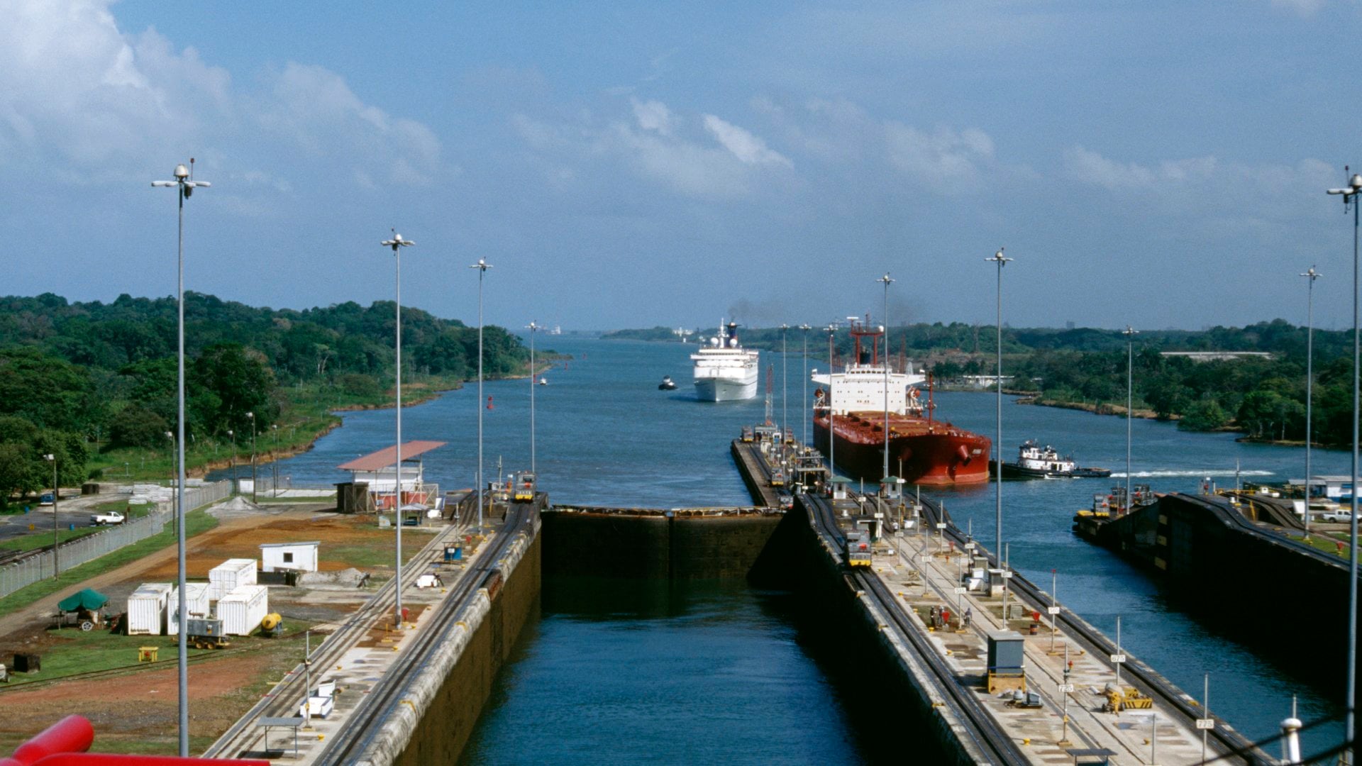 Ships entering Gatun Locks from the Atlantic in the Panama Canal. Ship on right is Panamax bulk vessel and carries grain, ship on left is a cruise ship.