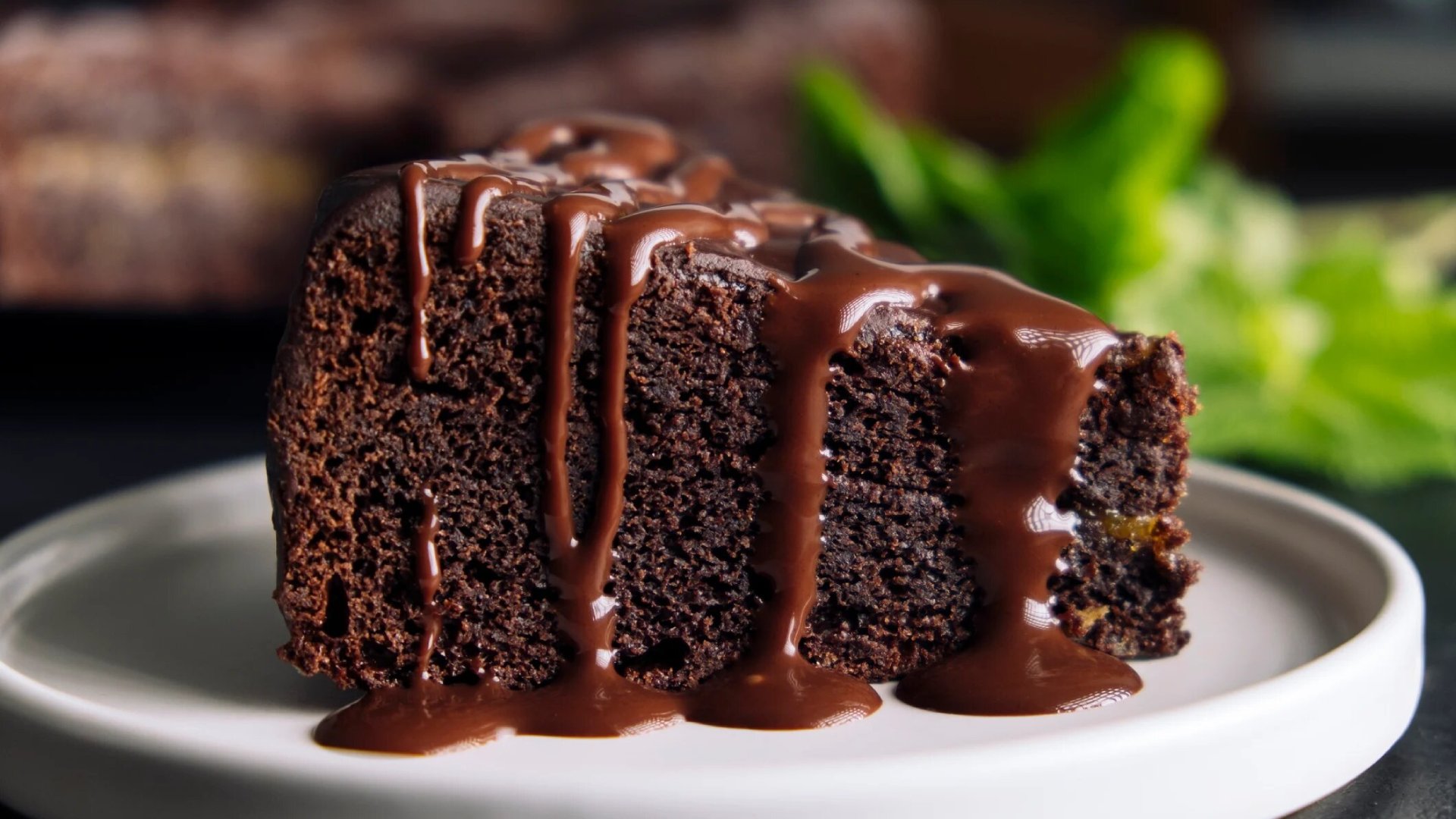 Slice of chocolate cake with glaze on a plate