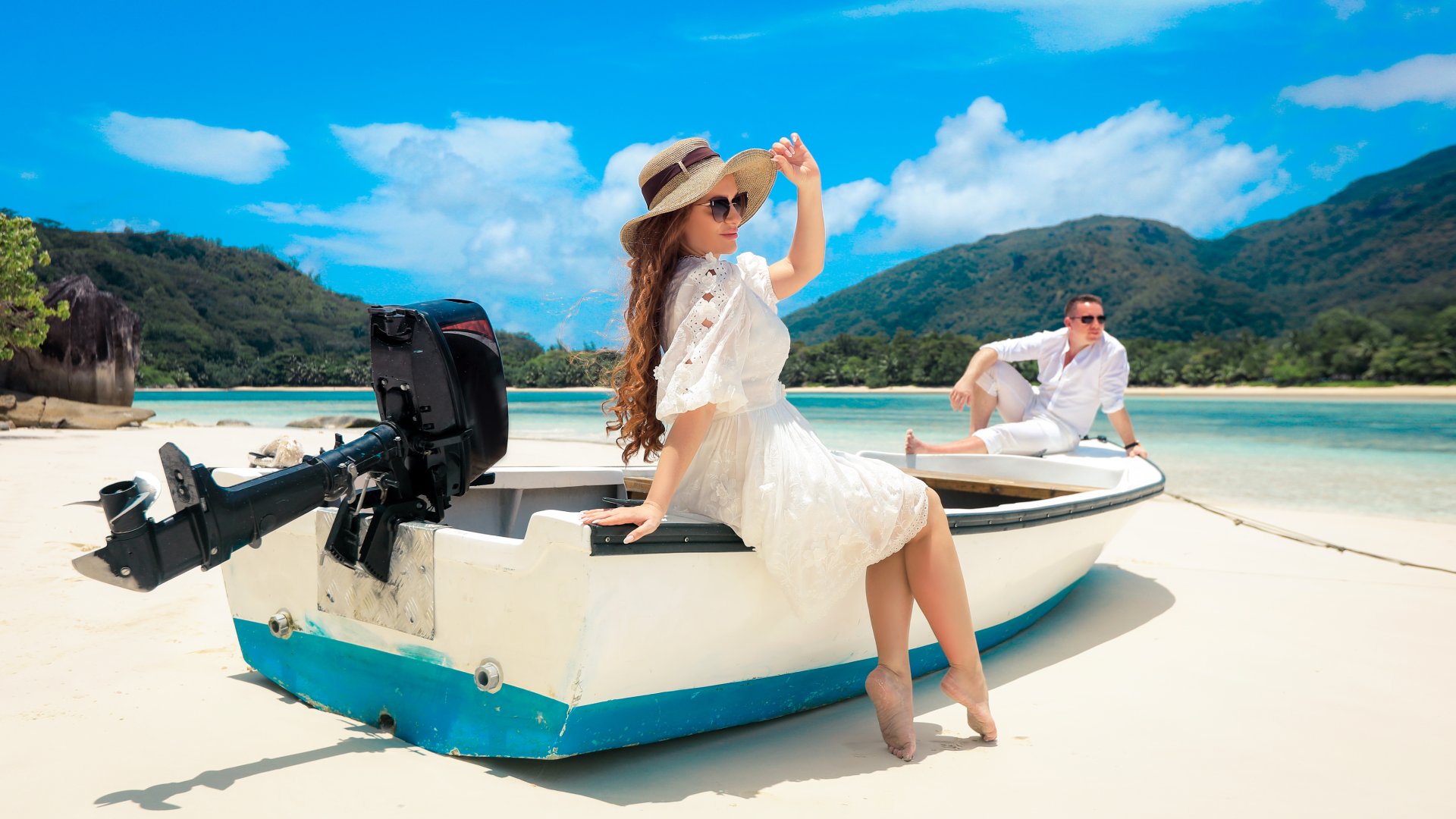 Two lovers and a boat on the paradise Seychelles, tropical island near Mahe