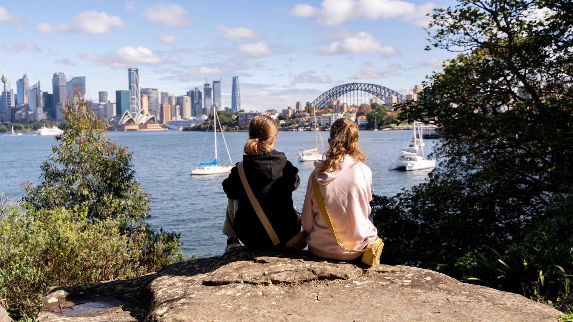 Two young girls looking at Sydney harbour.