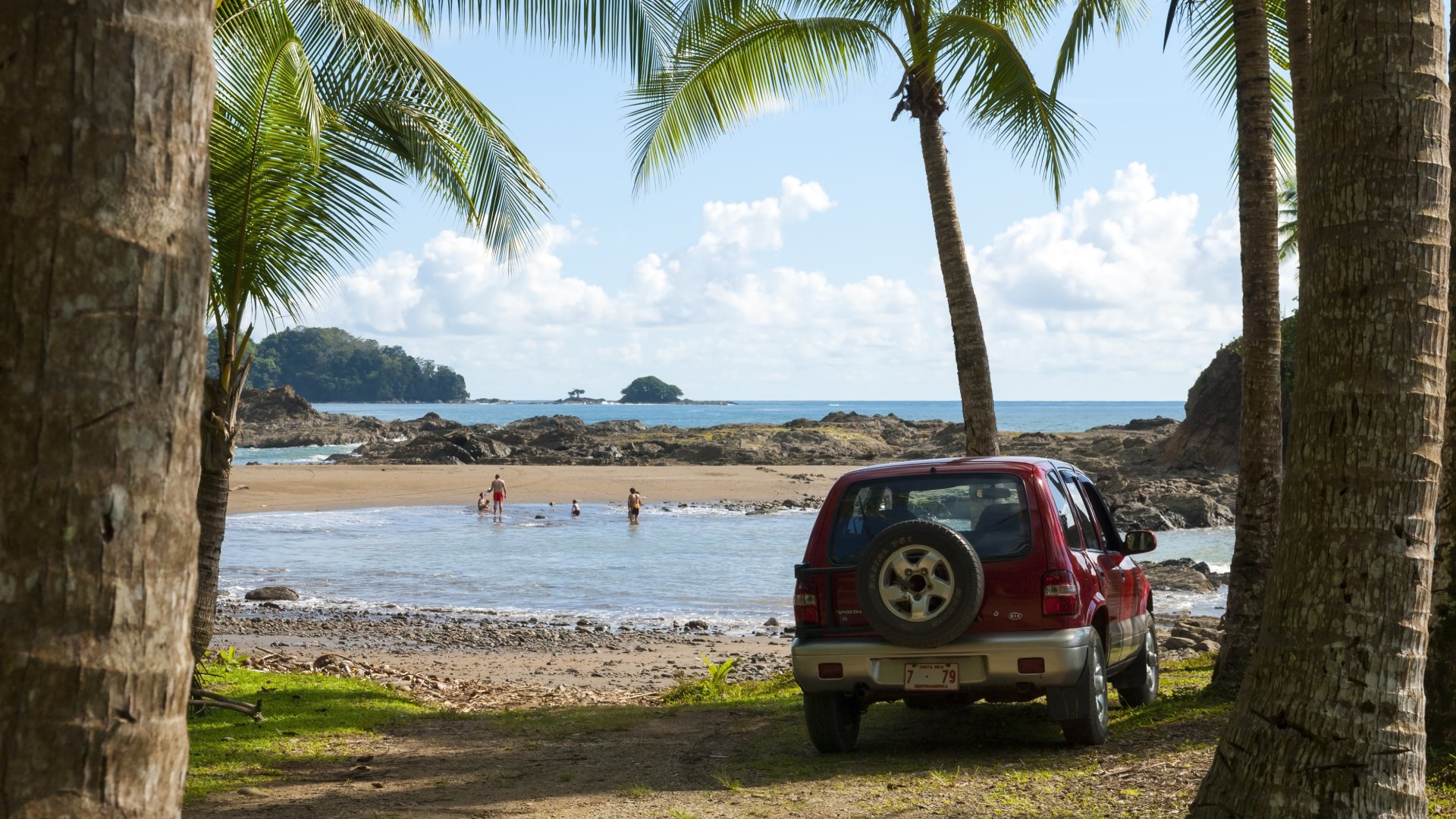 Vehicle and family at the tropical beach