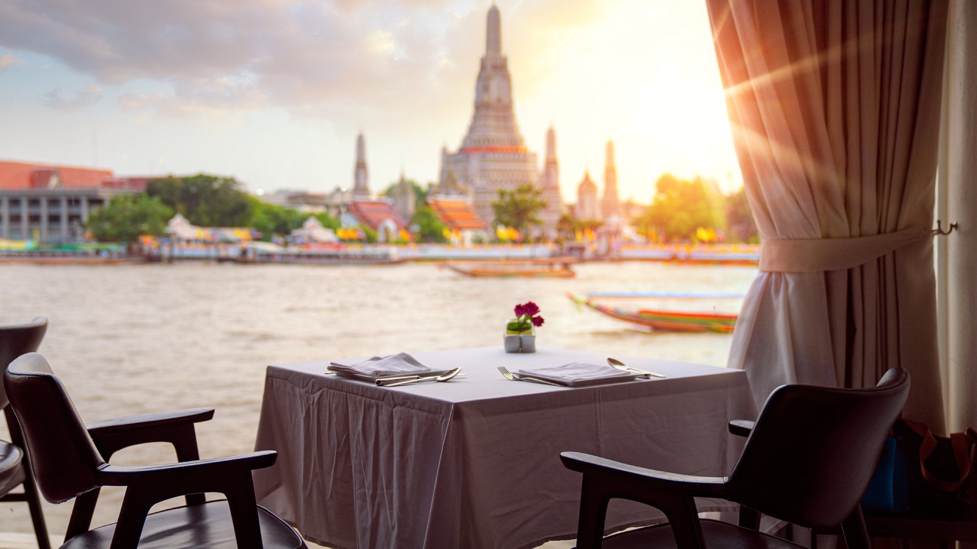 Bangkok, Thailand View of Wat Arun (Temple of Dawn), from riverside bar in Bangkok, Thailand