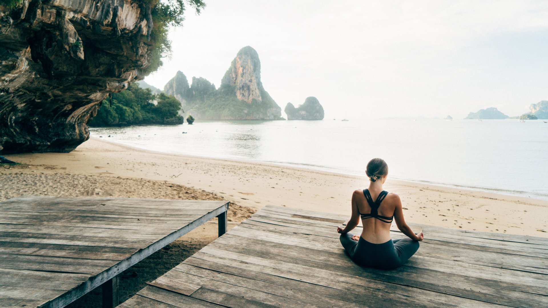 Thailand Woman doing yoga on the beach