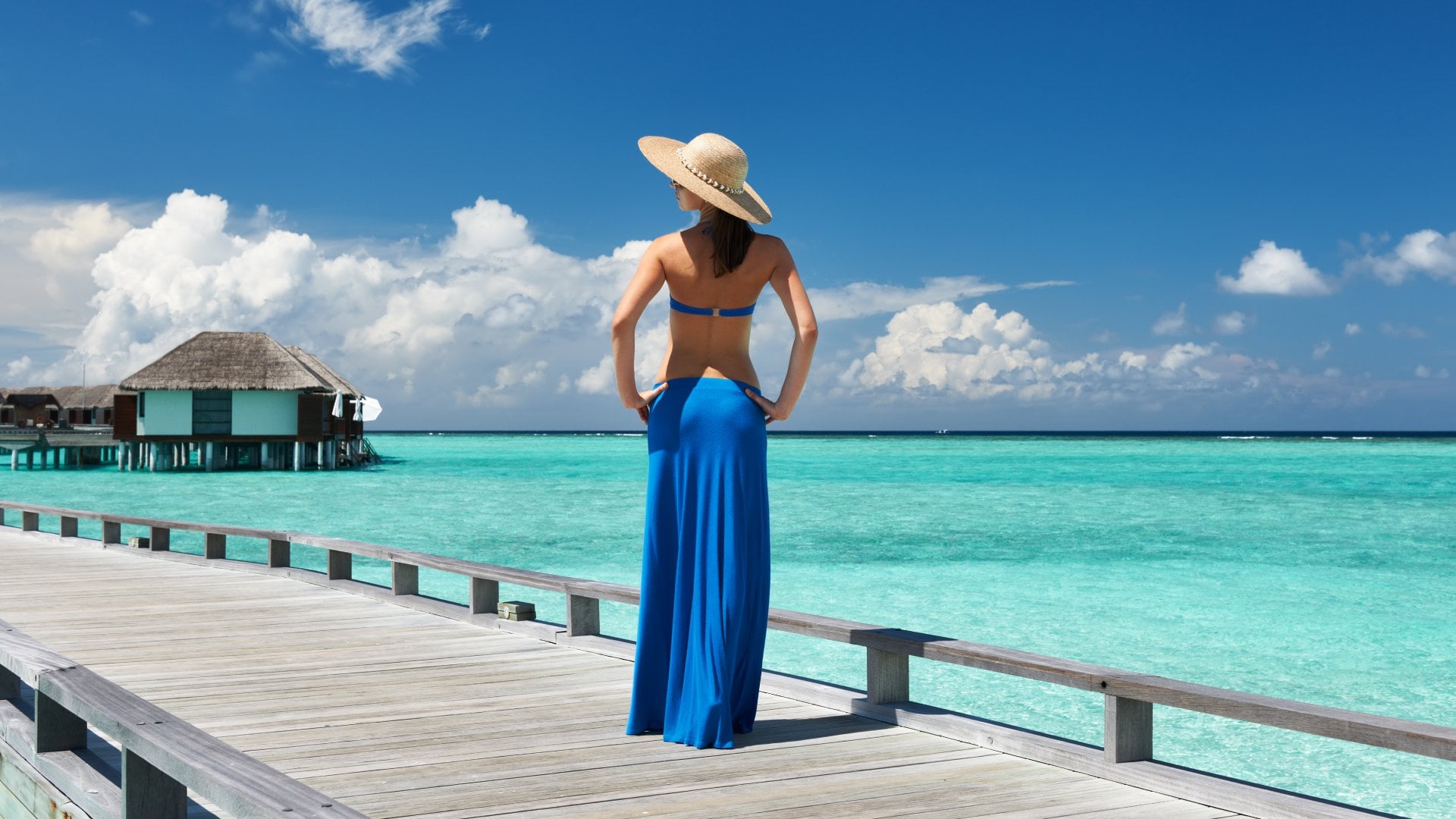 Woman on a Tropical Beach Jetty in the Maldives