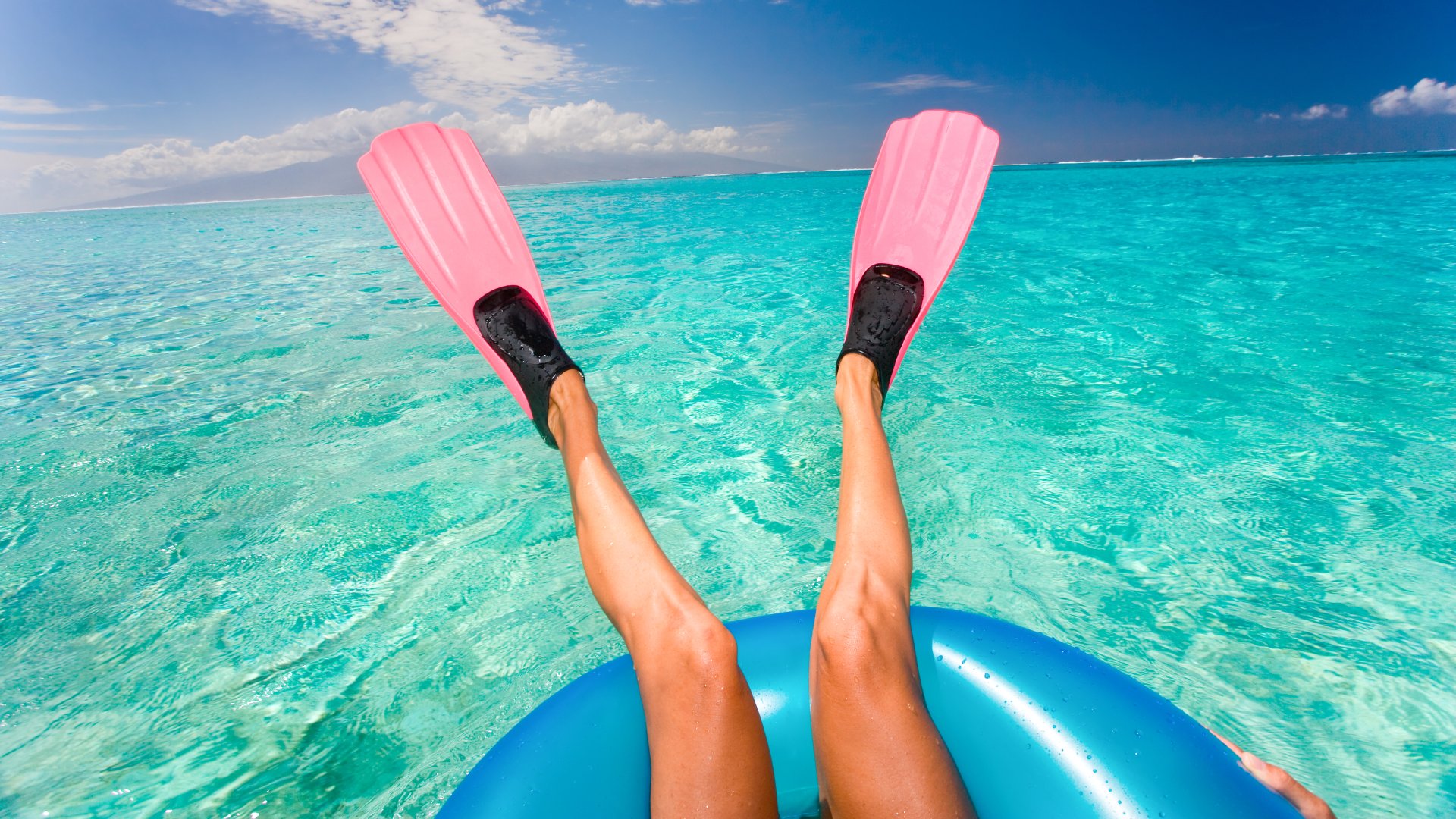 Woman with Pink Fins Floating in Turquoise Waters