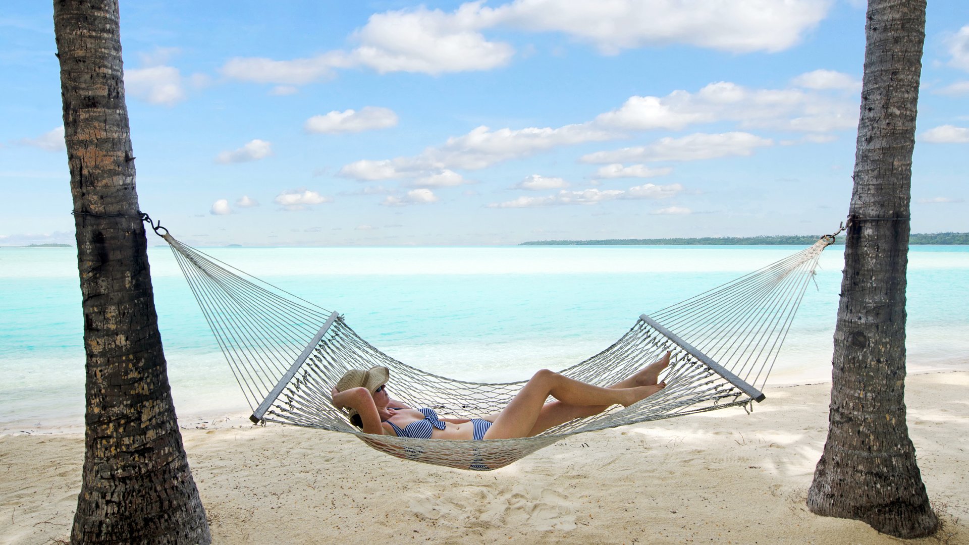 Young Woman Relaxing in Hammock in Aitutaki, Cook Islands