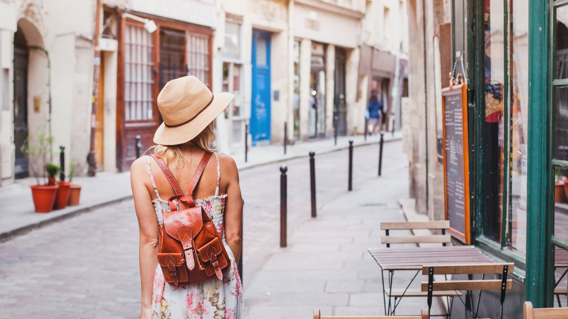 Young woman tourist walking on a street in Europe