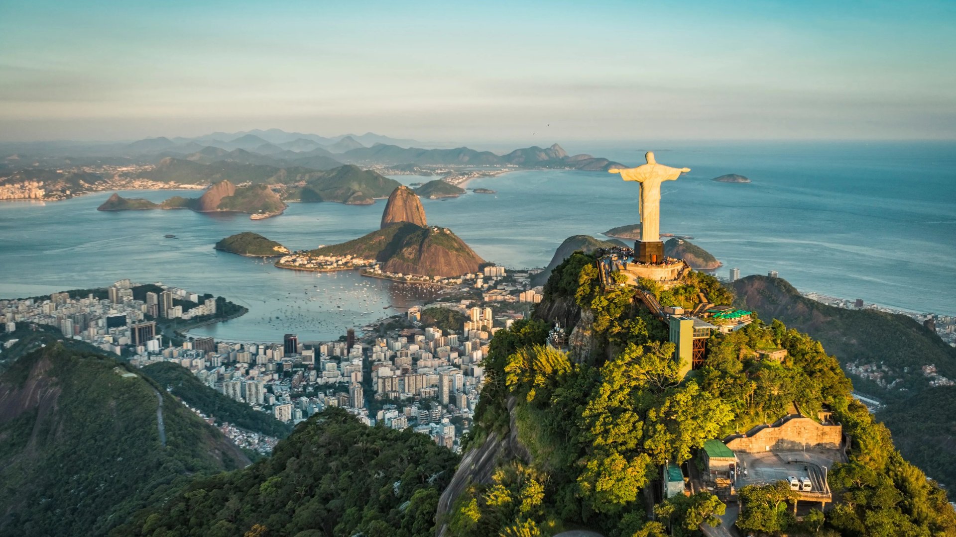 aerial view of Christ the Redeemer watching over Rio de Janeiro from his benevolent perch above the city