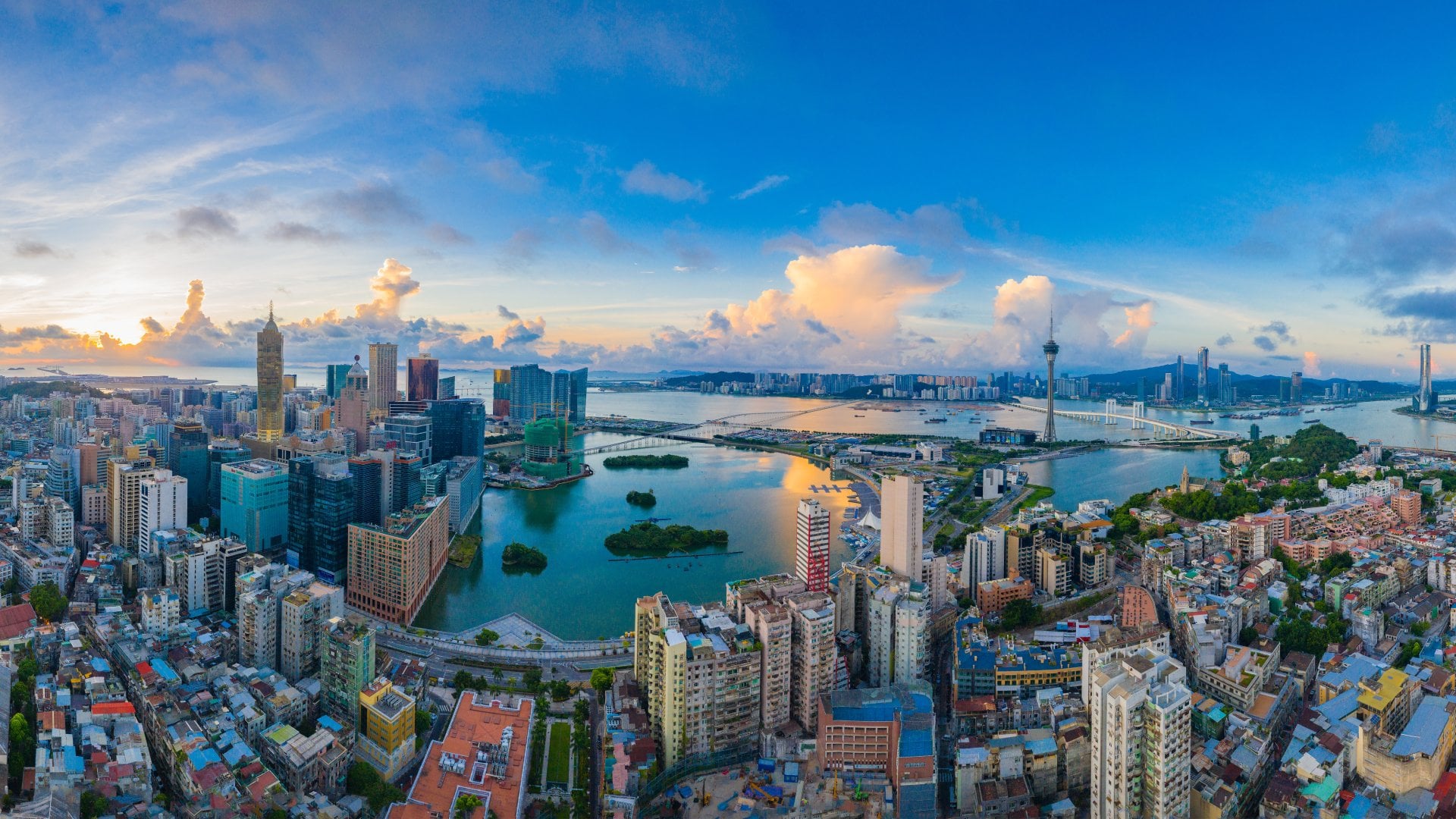 aerial view of a sprawling peninsula city next to the water