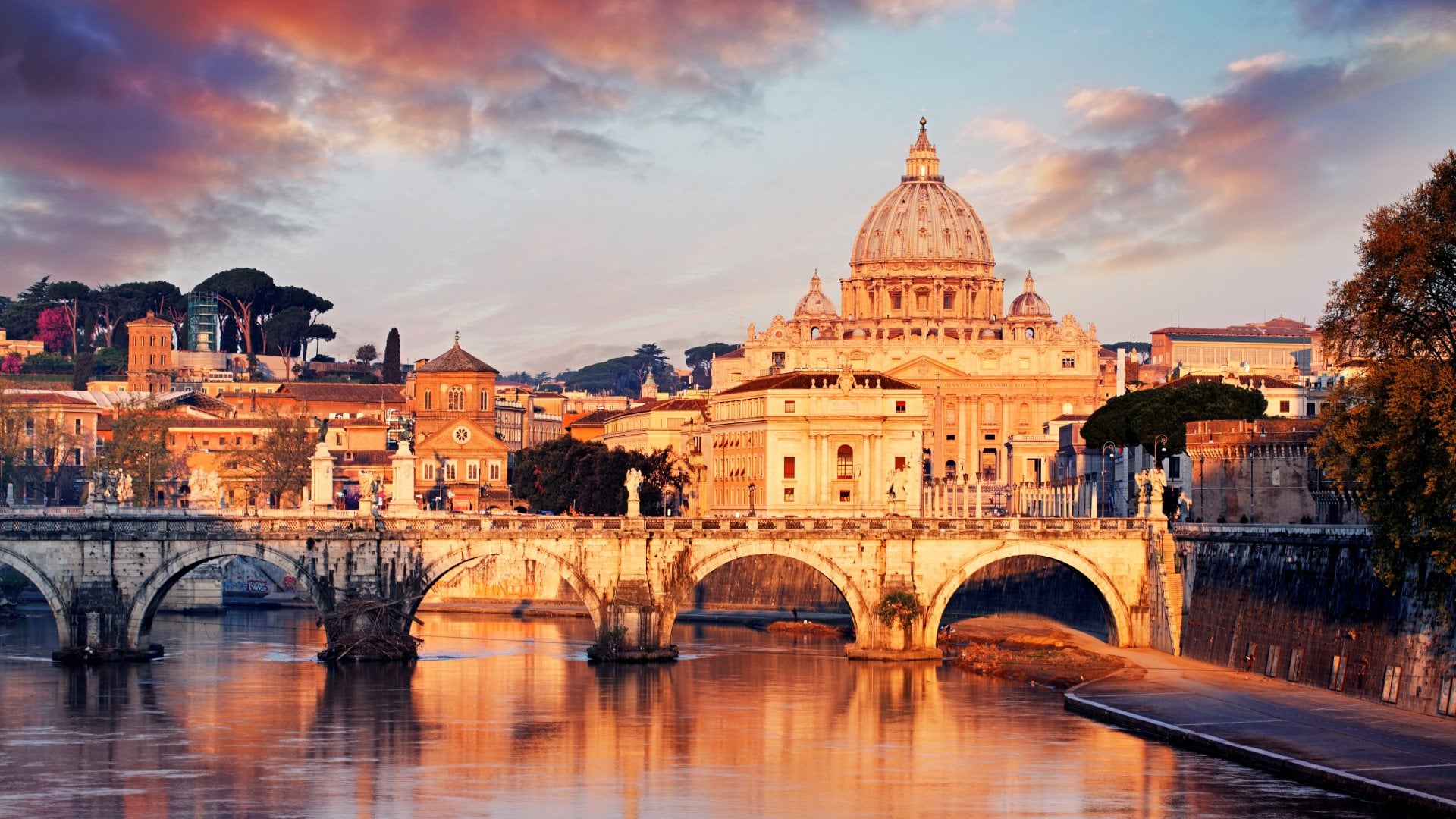 Church dome overlooking bridge and river at sunset