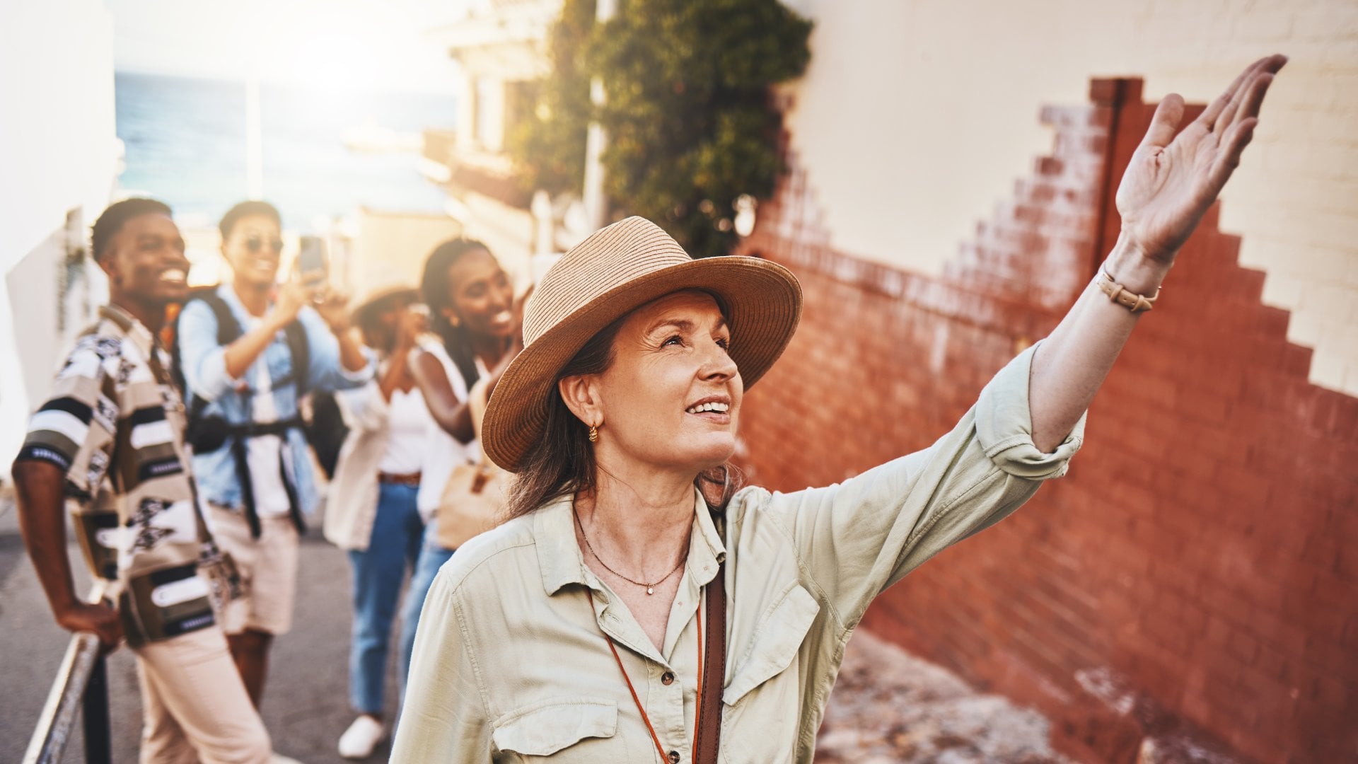 a tour guide leads a group of travels through an old city in Europe