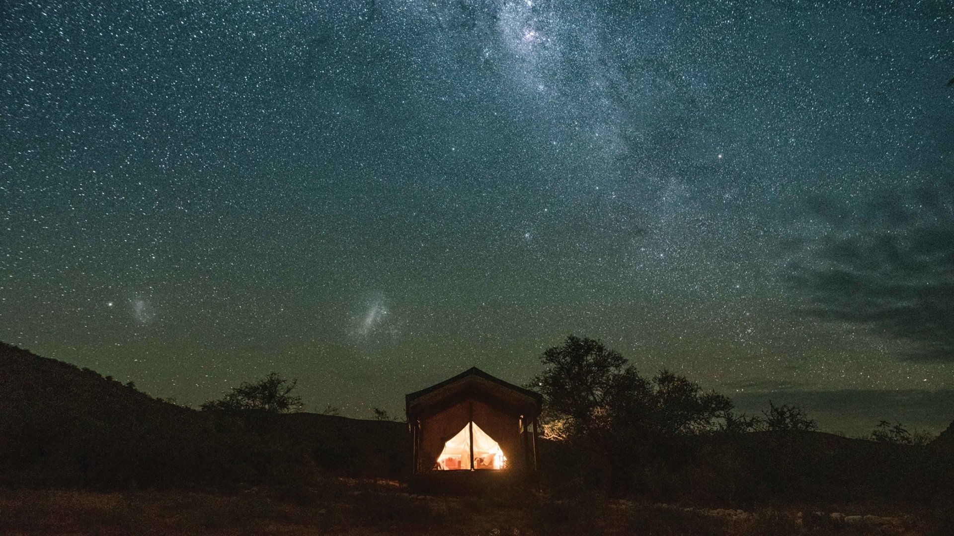 The brilliant colours of the Milky Way light up the dark wilderness of a tent on the Western Cape.