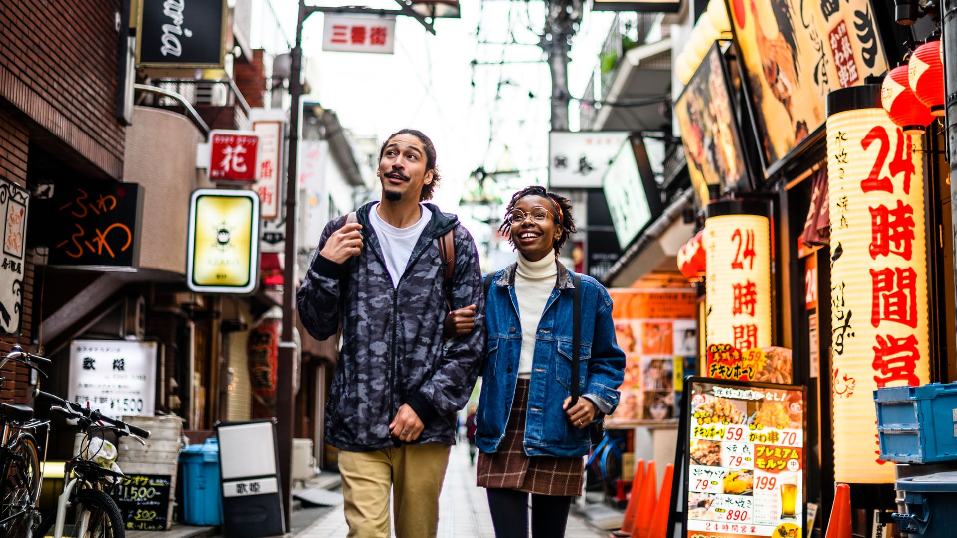 A couple walks through the streets of Tokyo in Japan