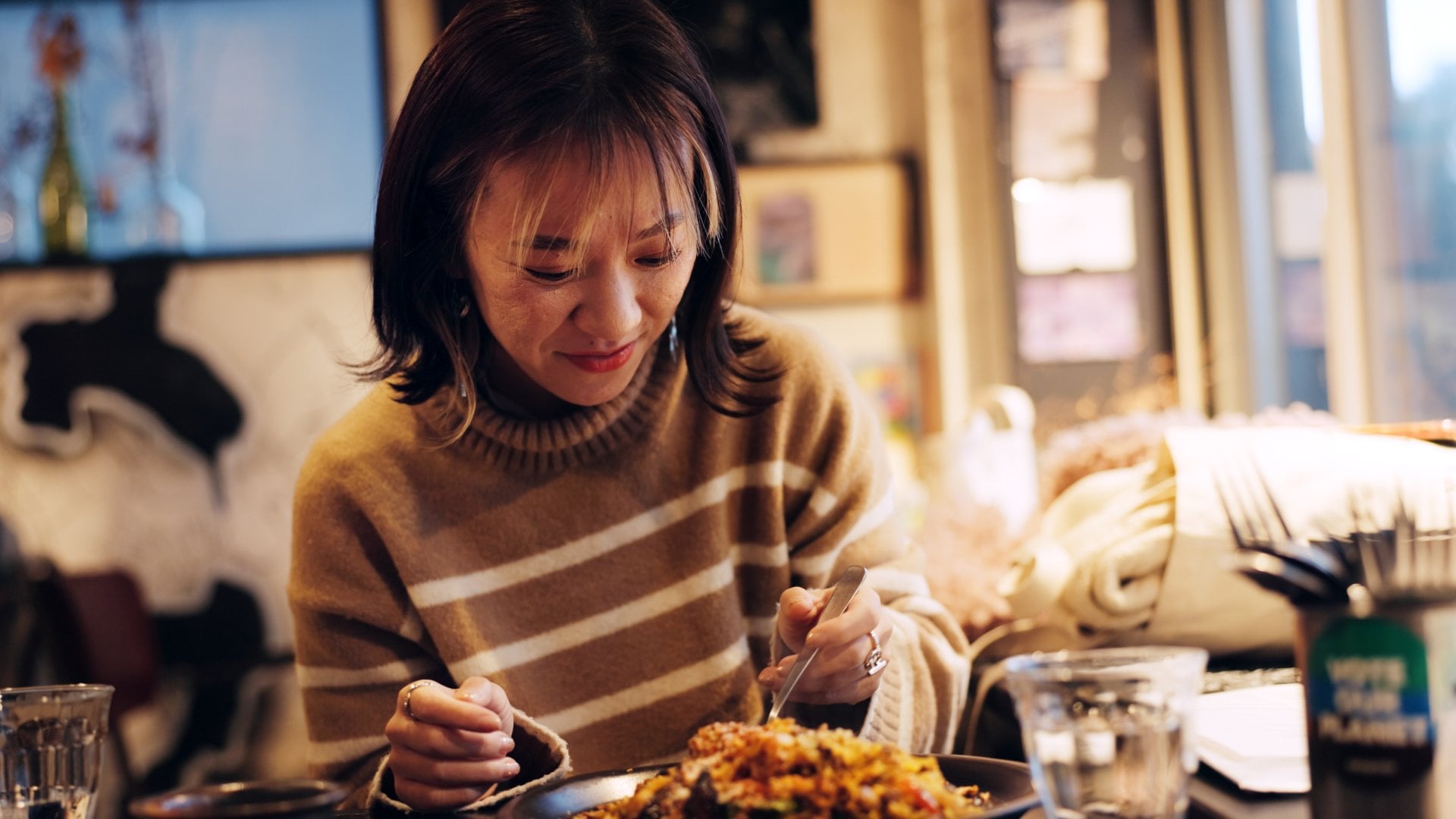 woman at a restaurant eating a meal