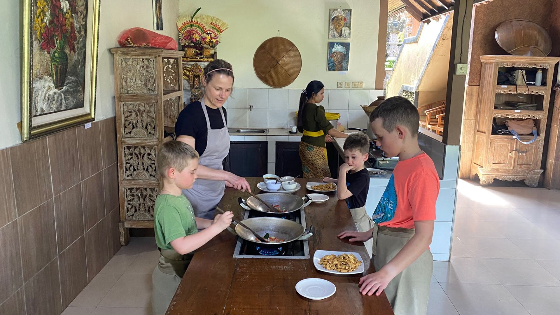 Linda Warner and her kids involved in a cooking class on their family vacation to Bali