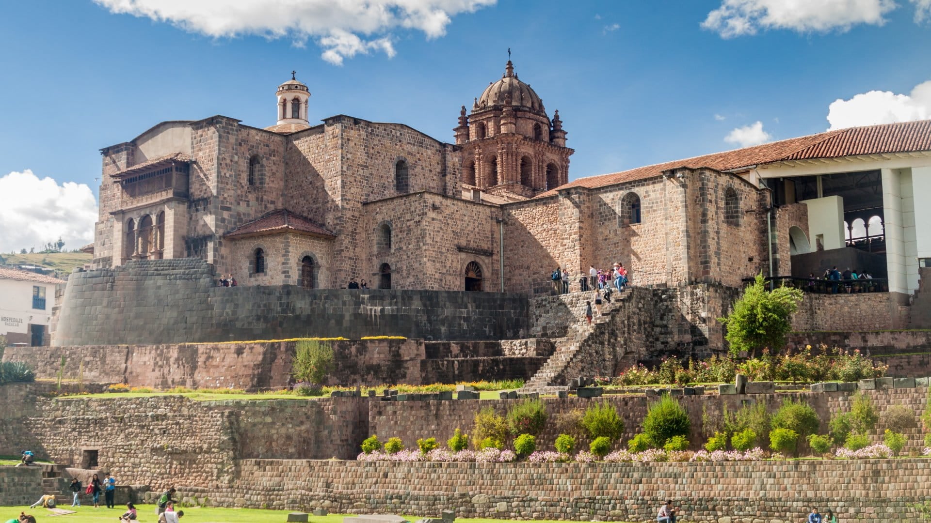 church built on top of ruins in front of walls and garden