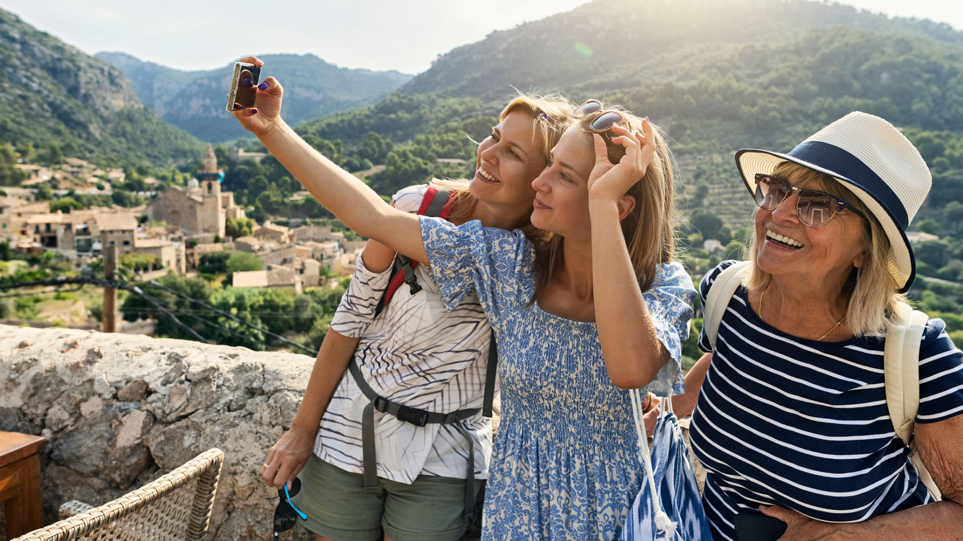 Three women pose for a photo at a lookout in Valldemossa, Majorca, Spain