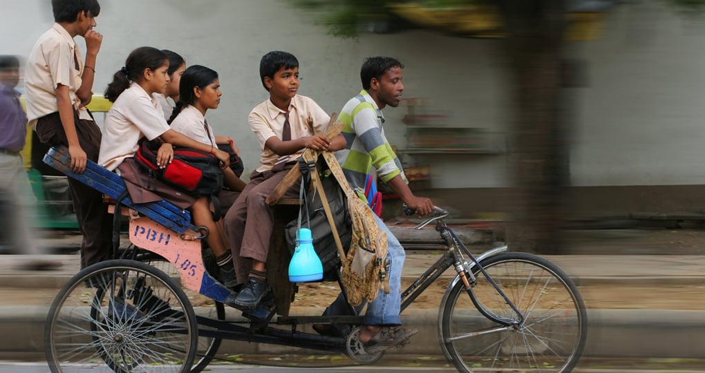 An Indian family riding a cycle rickshaw An Indian family riding a cycle rickshaw