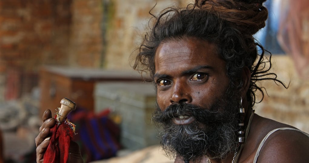 Shaiva sadhu (holy man) smokes a pipe in Kathmandu valley Shaiva sadhu (holy man) smokes a pipe in Kathmandu valley