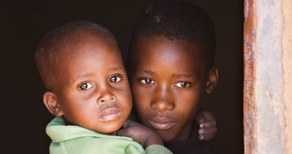 Small children looking out the window.