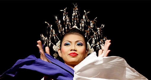 A women from the indigenous Iban people performs A women from the indigenous Iban people performs
