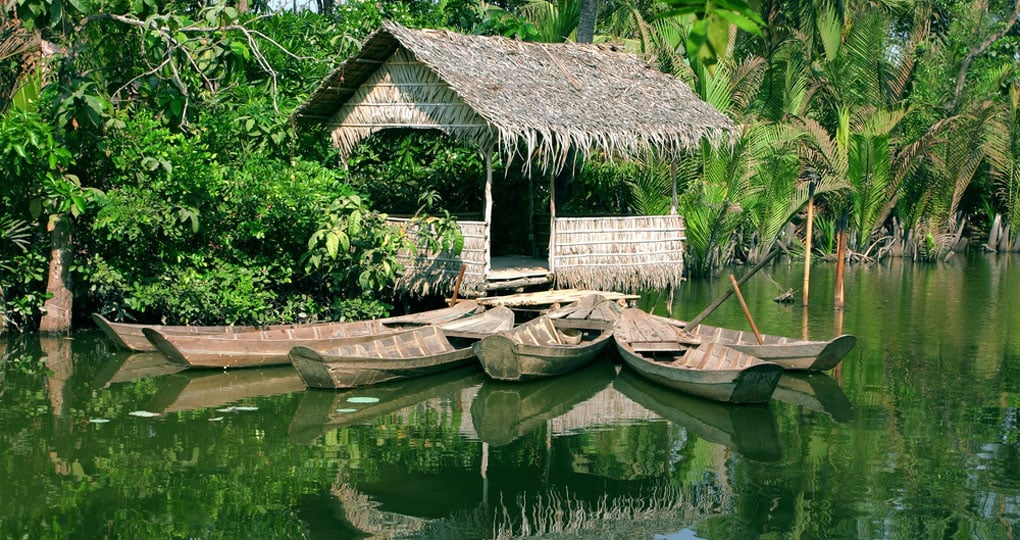 A cottage and boats on the Mekong A cottage and boats on the Mekong