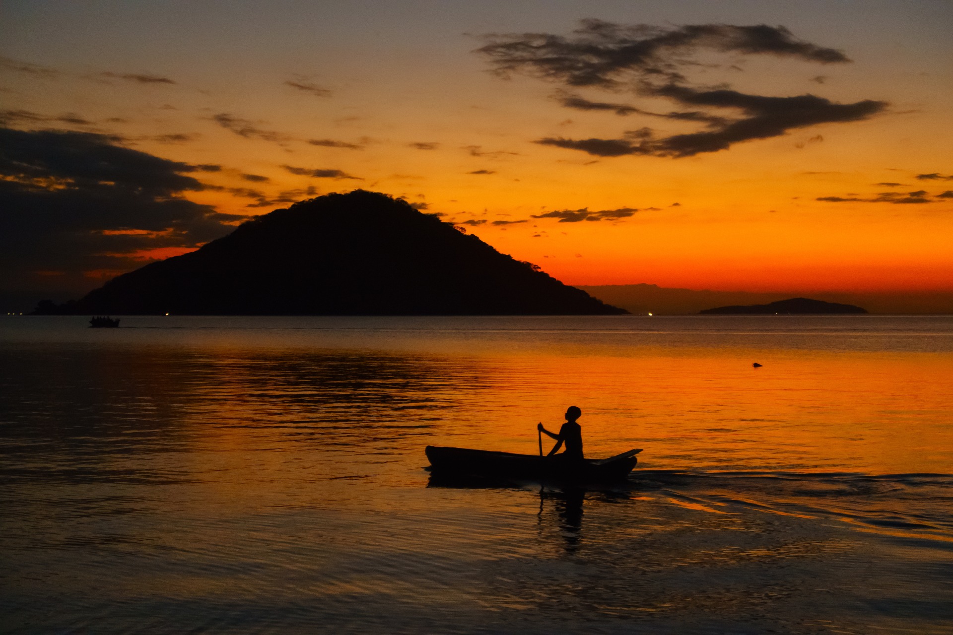 Lake Malawi Fisherman on boat at sunset in lake