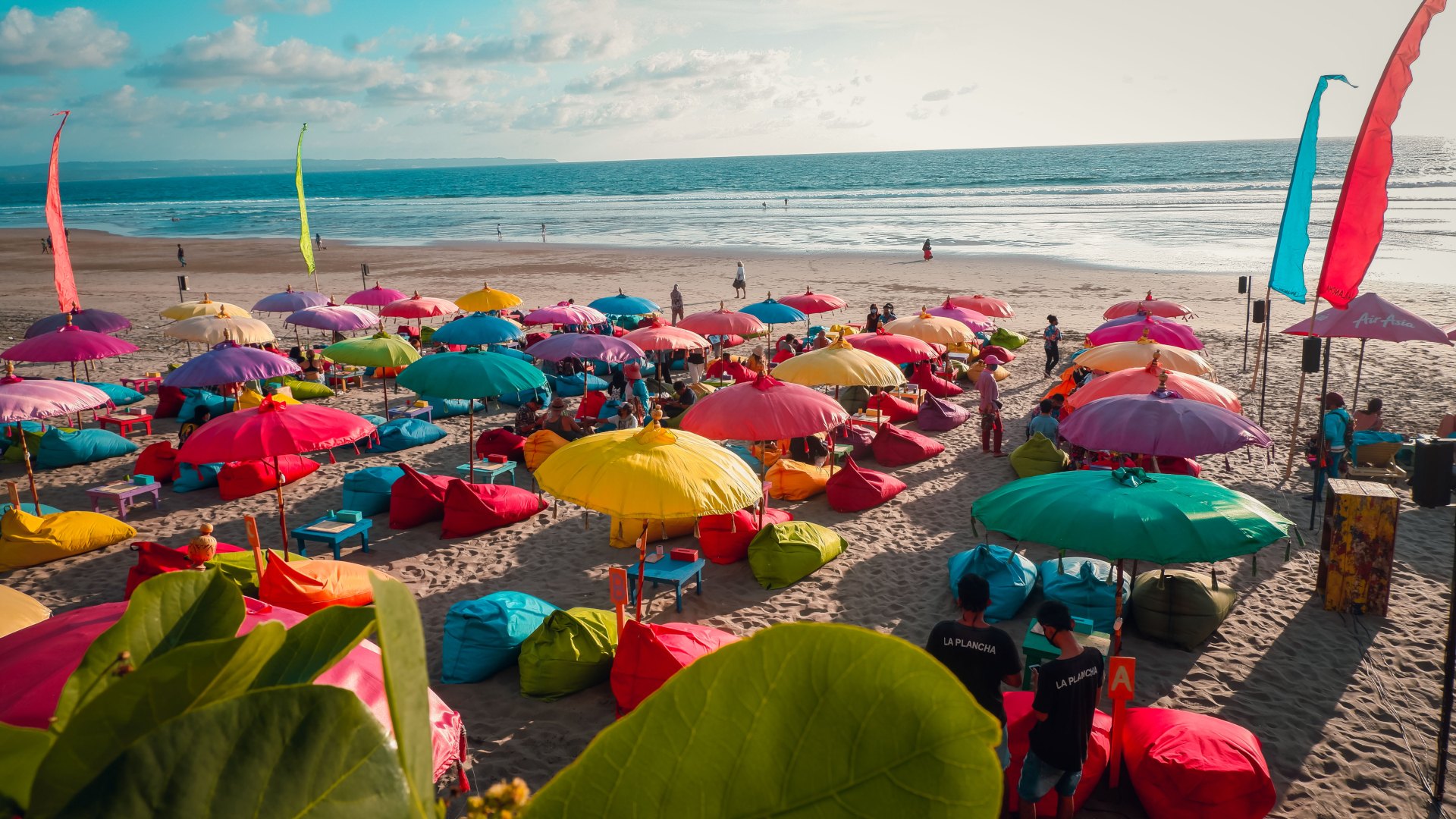 Colourful beach umbrellas with view of Double Six Beach, Seminyak, Bali, Indonesia