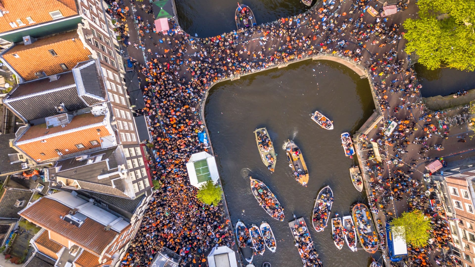 Canal boat parade on Koningsdag Kings day festivities in Amsterdam. Birthday of the king