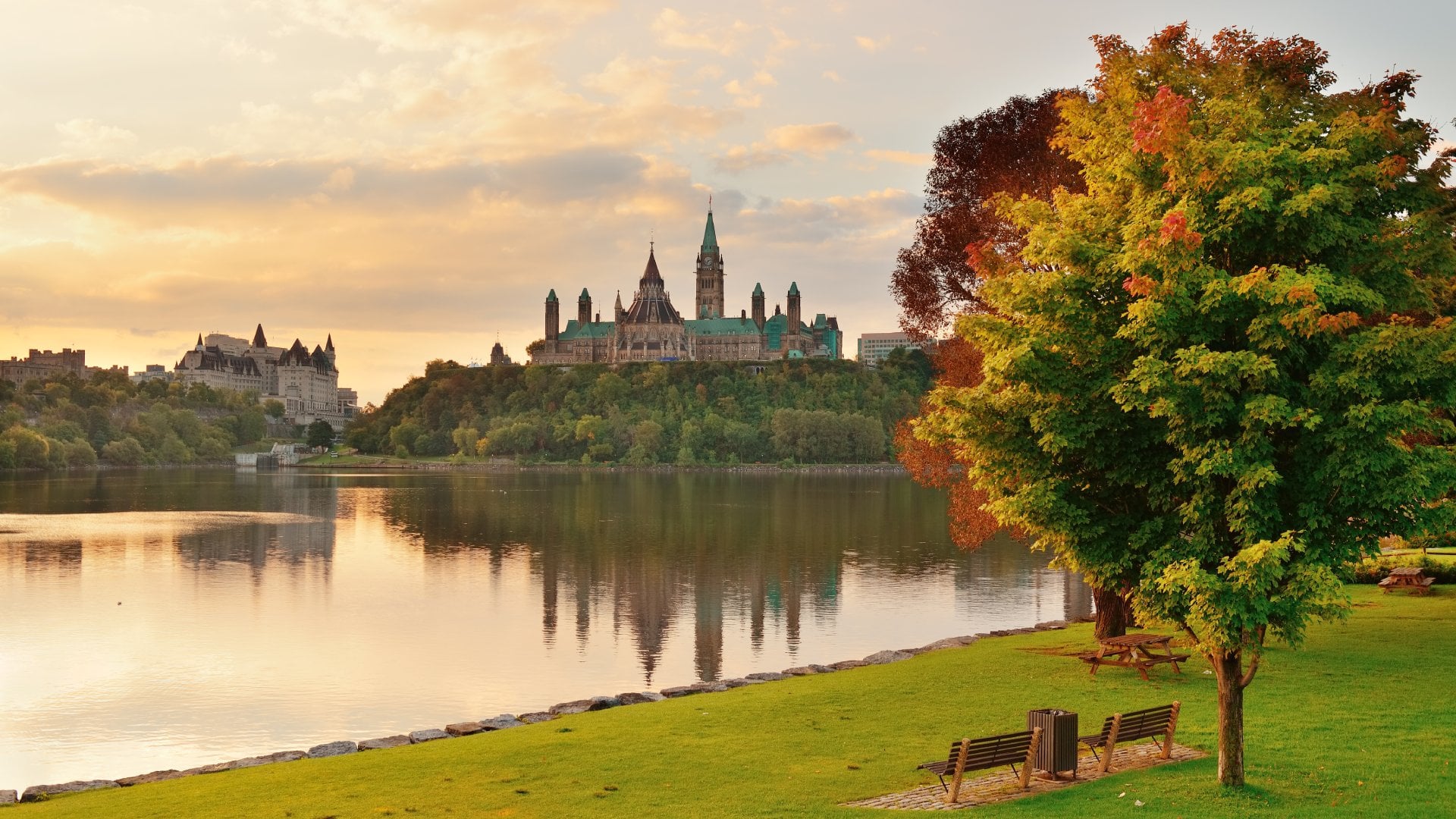 Ottawa city skyline with Parliament Hill at sunrise in the morning park view over river