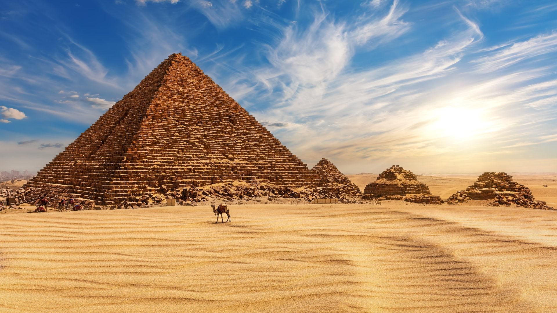 The Pyramid of Menkaure at sunset in Egypt and a camel nearby