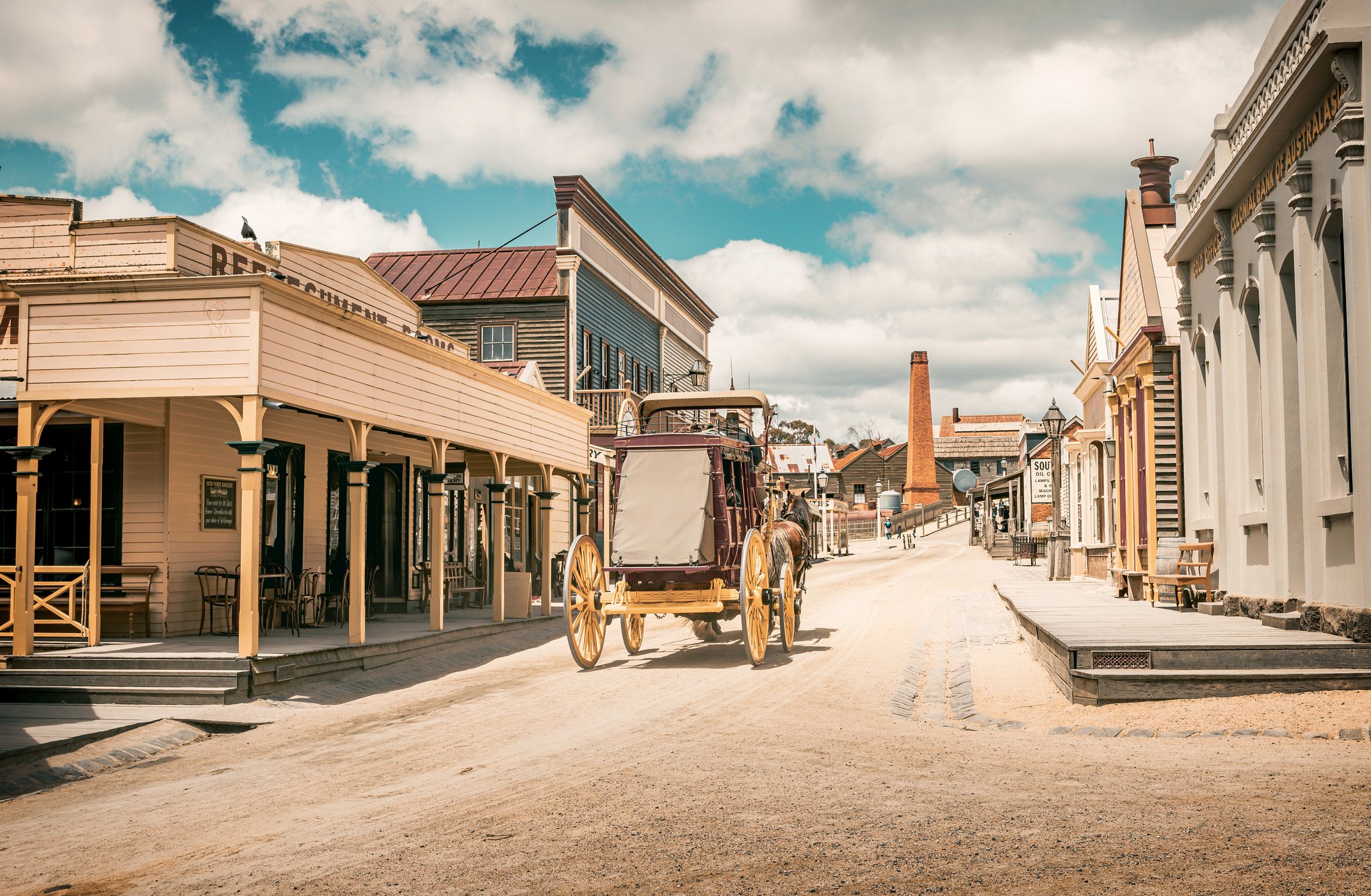 An old horse-drawn carriage moves through the replica mining town of Sovereign Hill in Ballarat, Australia