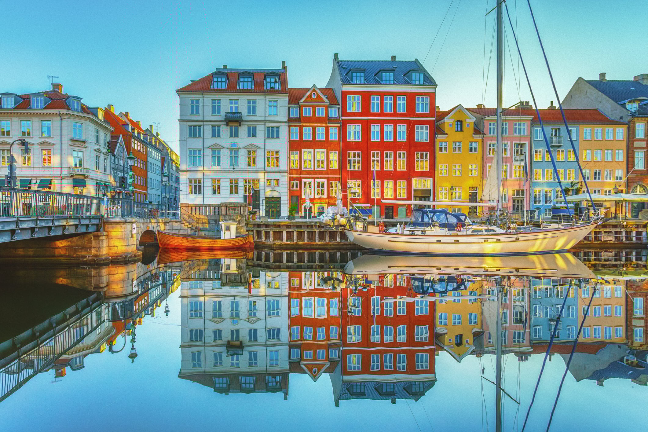 View of clear waters reflecting the buildings of Nyhavn along the canals of Copenhagen, Denmark