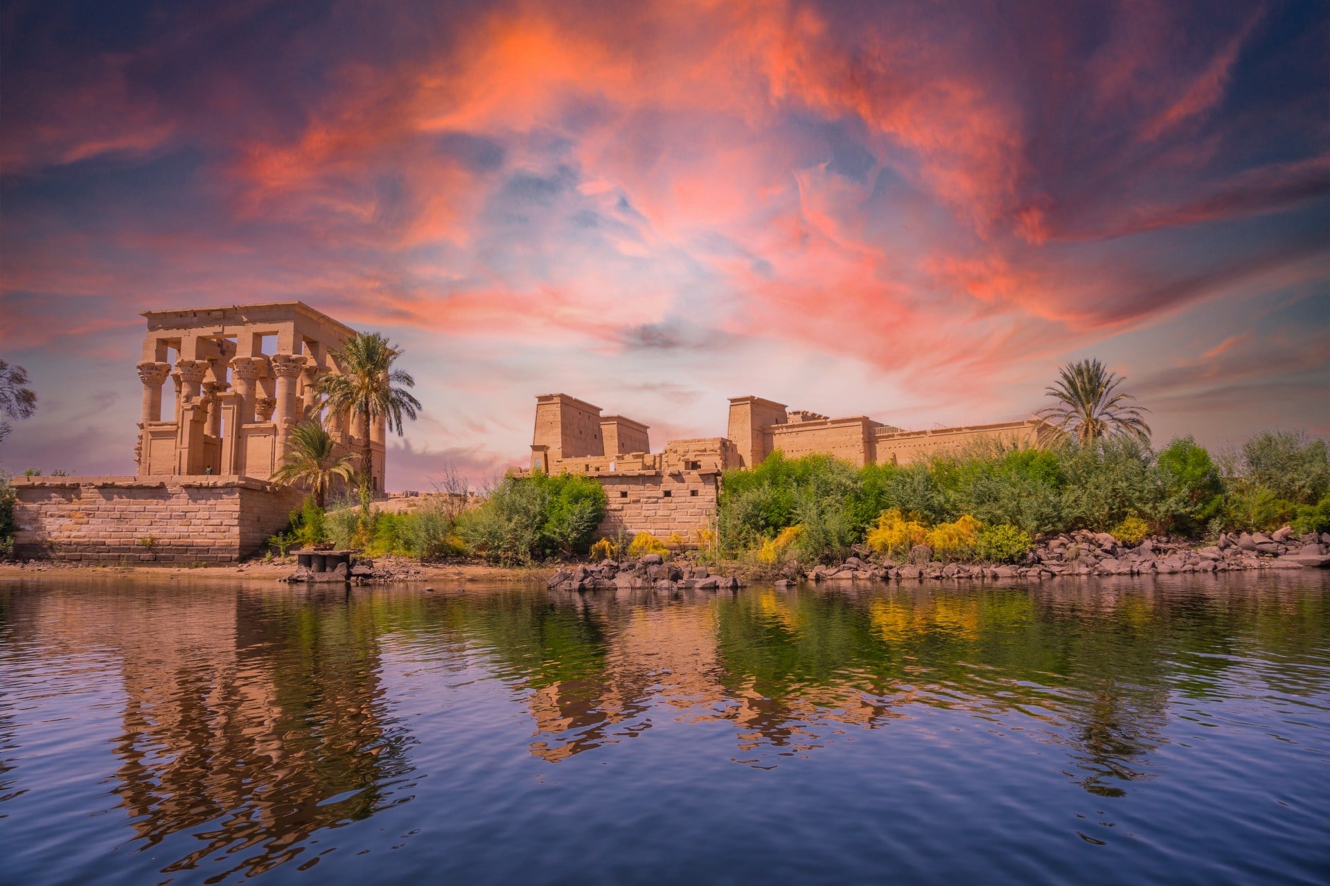 Temple of Philae, Aswan, Egypt Incredible orange sunrise at the temple of Philae, a Greco-Roman construction seen from the Nile river, a temple dedicated to Isis, goddess of love