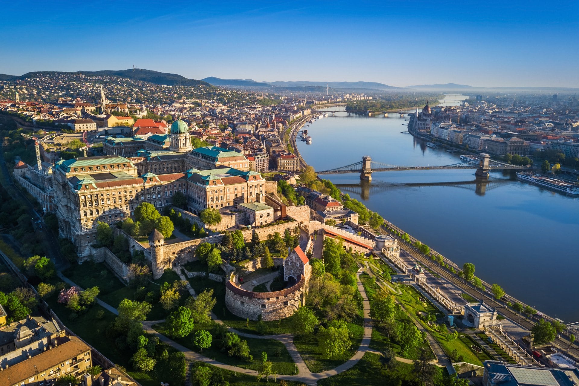 Beautiful aerial skyline view of Budapest at sunrise with Szechenyi Chain Bridge over River Danube, Matthias Church and Parliament
