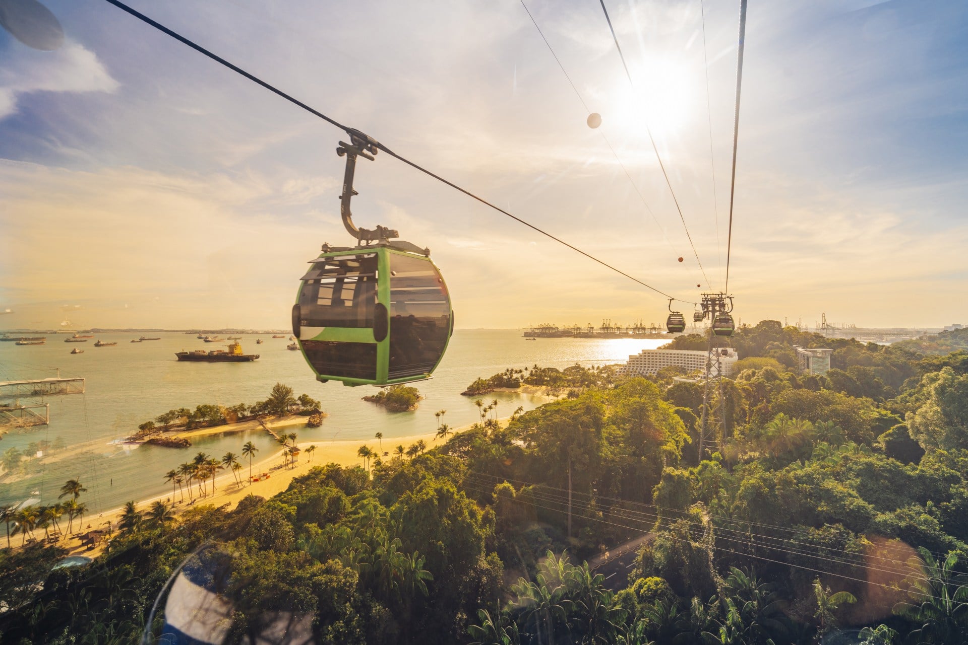 Sentosa Island Cable car trip to Sentosa Island, Singapore. Aerial view showing lush green forest and sandy beach below