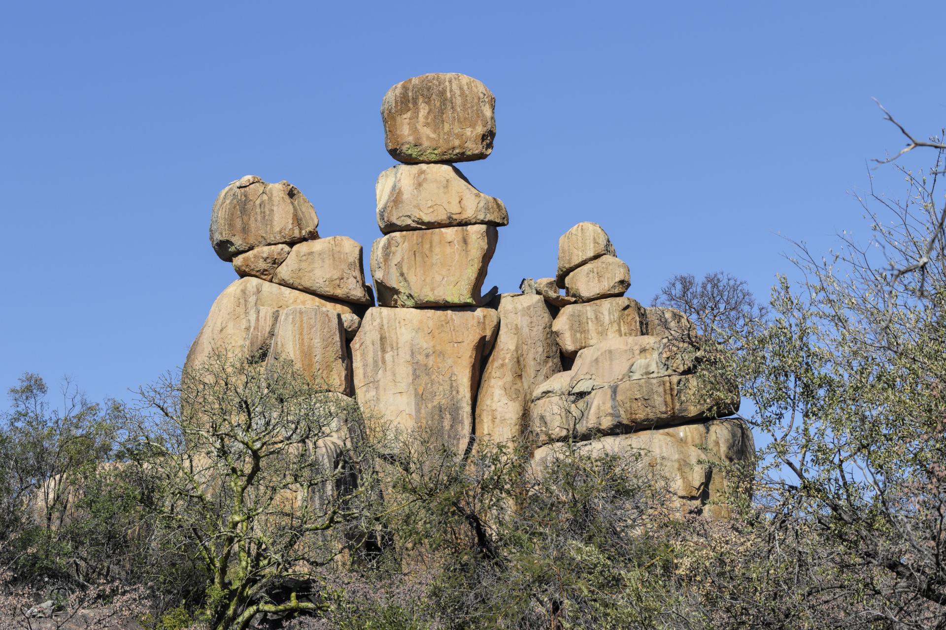 Matopos means "bald heads" in the Ndebele language of Zimbabwe. The name refers to the many inselbergs that stand on top of hillsides in Matobo National Park. This inselberg, or kopje, resembles a small man riding a scooter.