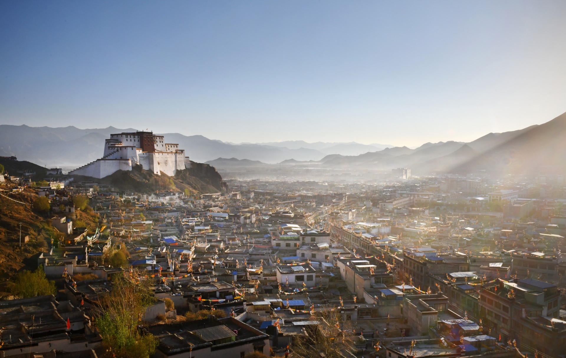 Cityscape of Tibet's second largest city Shigatse - dominated by the Dzong and distant Himalayan mountains Samzhubzê District