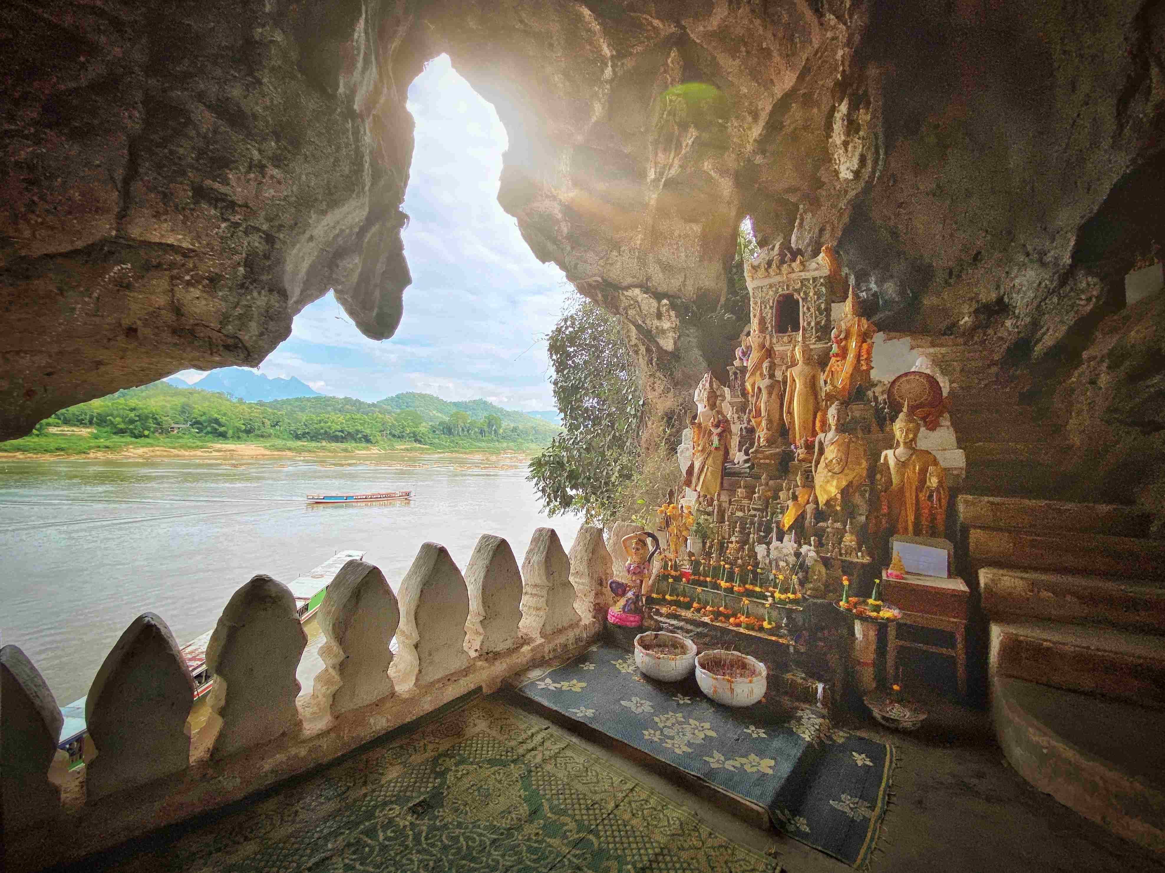 Pak Ou Cave Sunbeam into the Pak Ou Cave Buddha Shrine at Tham Ting Buddhist Cave. Mekong River, Luang Prabang, Laos