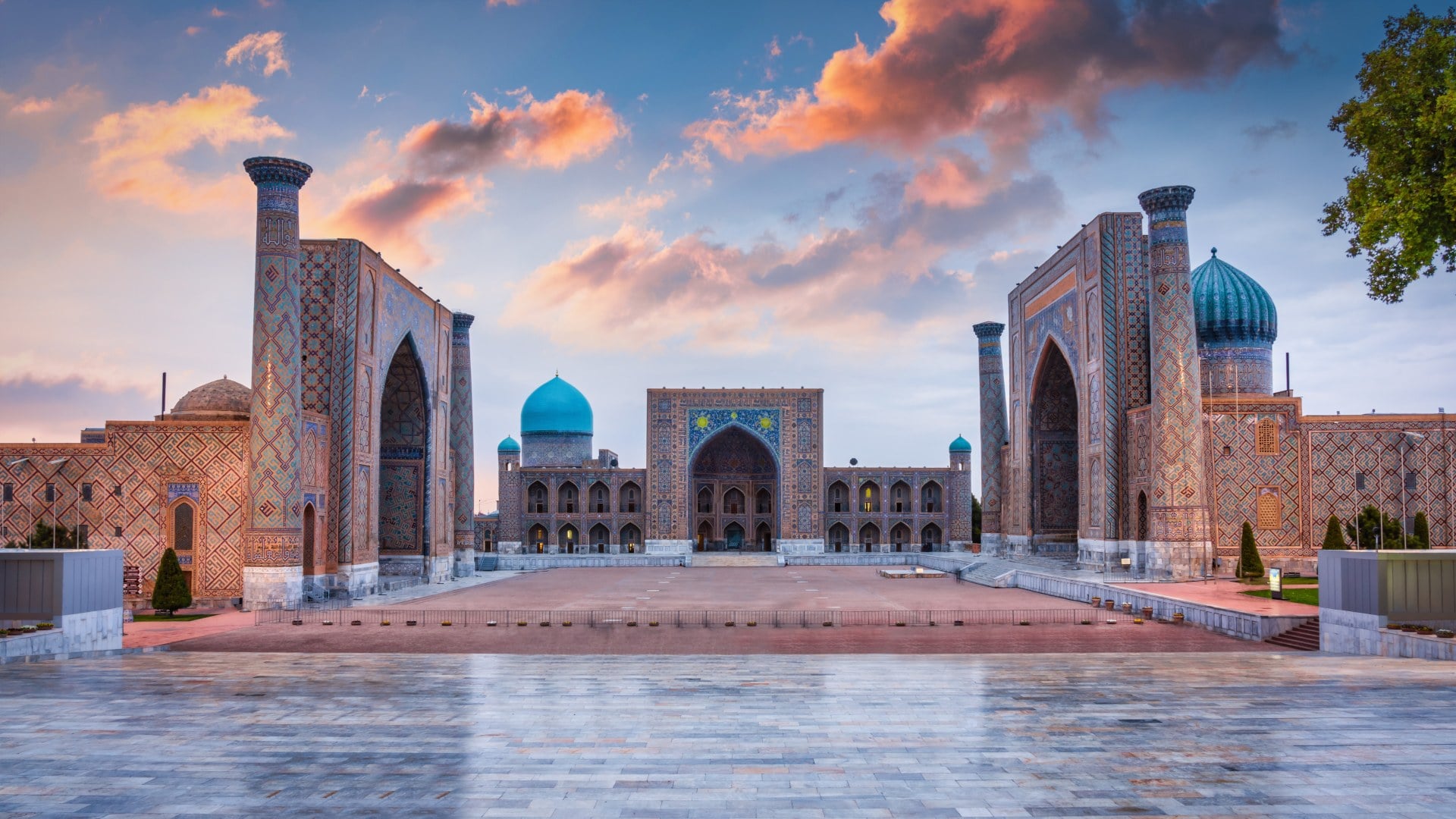 Samarkand Registan Square with Sher-Dor, Ulugh Beg and Tilya-Kori Madrasahs under colorful moody sunset twilight cloudscape