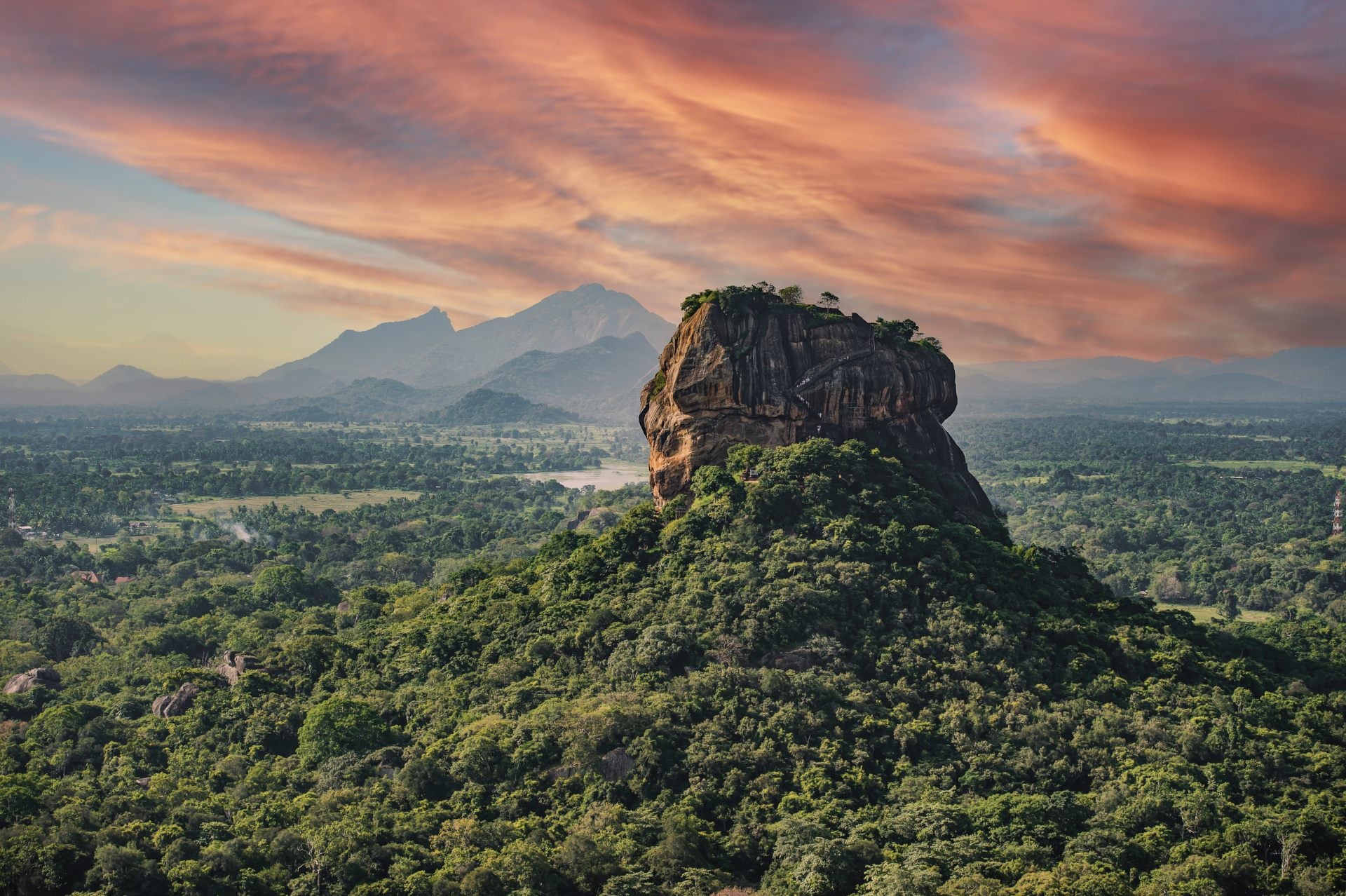 "View of the Lion rock surrounded by green rich vegetation, photo taken from Pidurangala Rock in Sigiriya, Sri Lanka."