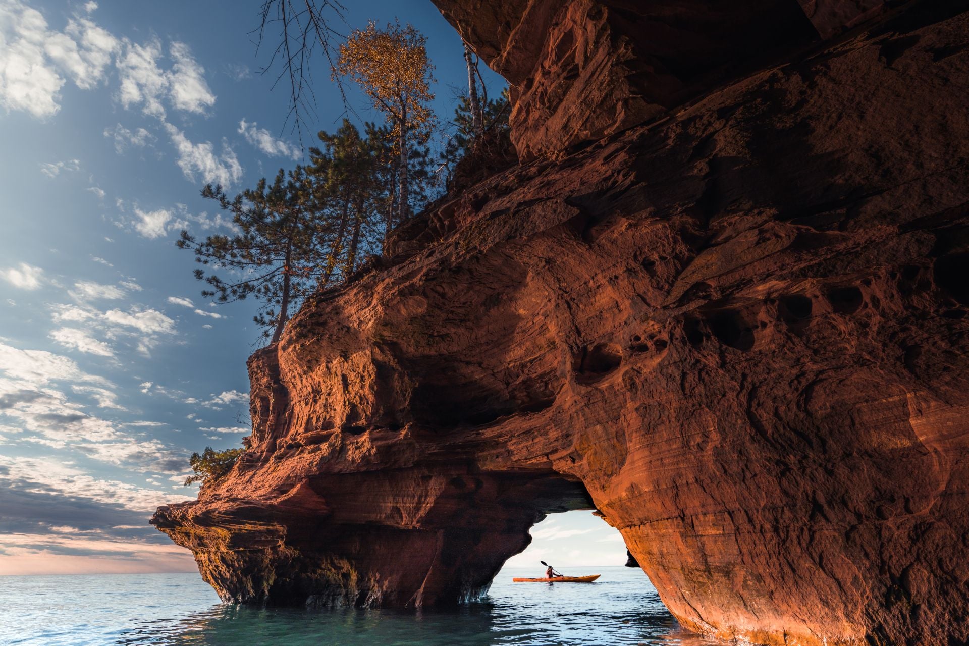 A lone kayaker exits a sea cave on The Apostle Island National Lakeshore in Wisconsin