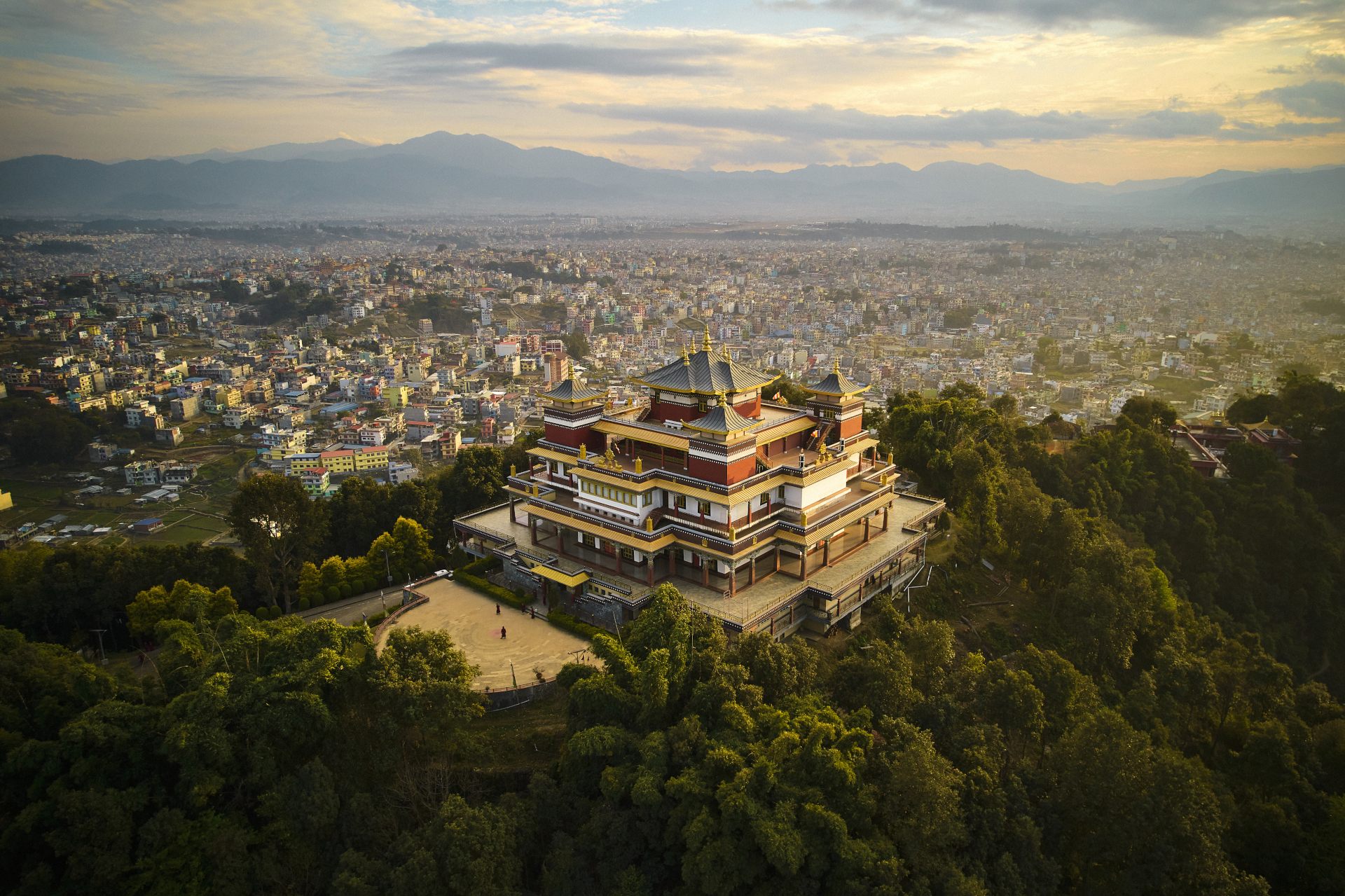 "Pullahari Monastery, Buddhist pilgrimage site on northern hill in Kathmandu Valley with city and mountains in background. "