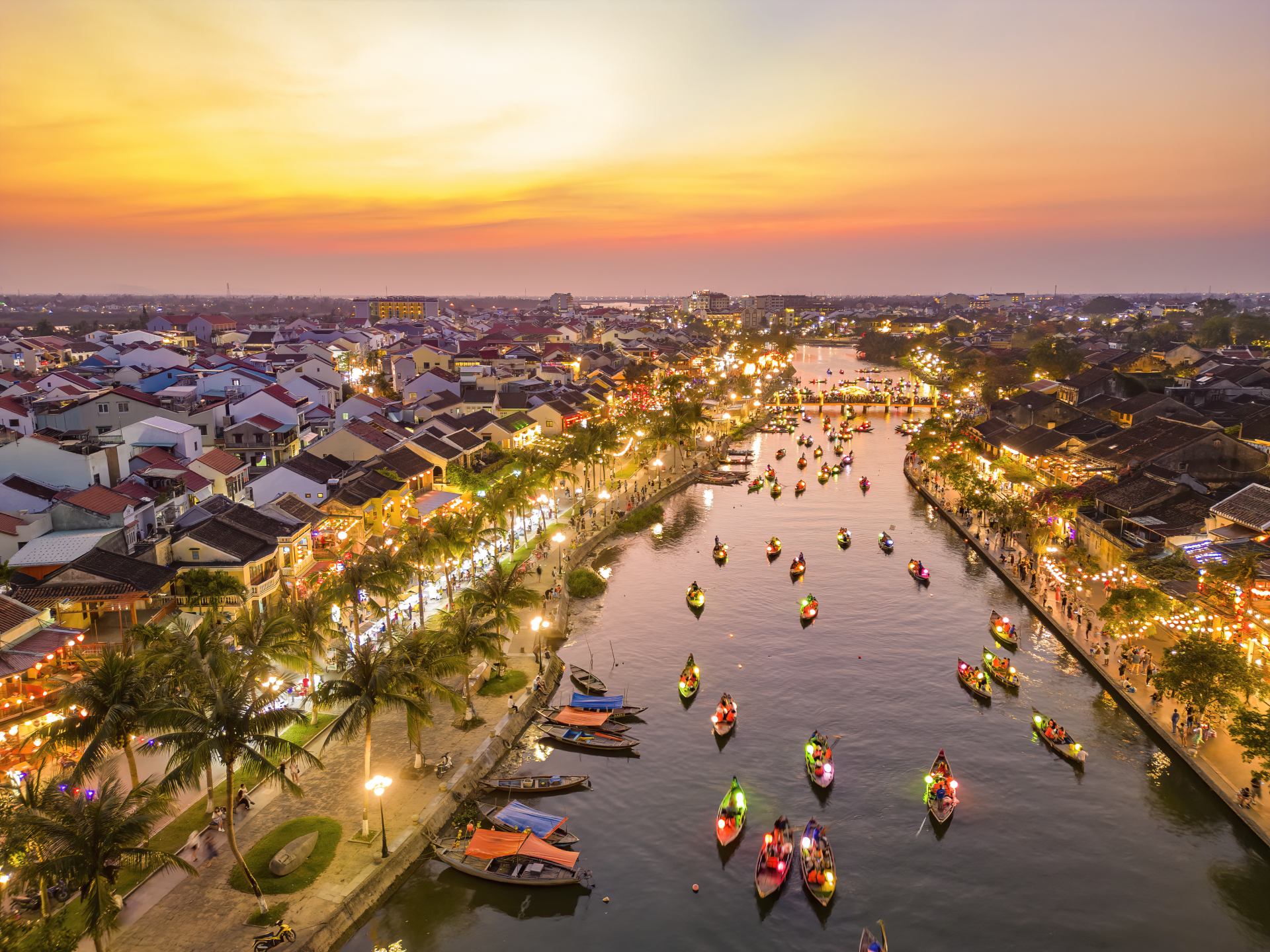 Thu Bon River Hoi An at dusk with boats cruising on Thu Bon River with lanterns