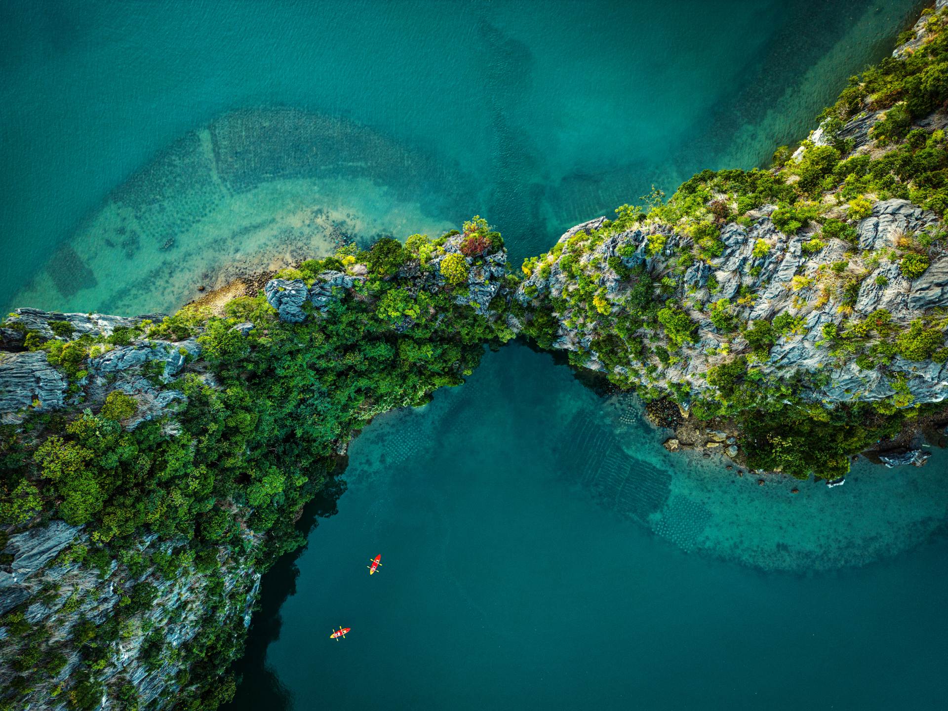 Vietnam Drone view on rocks and canoes floating on turquoise water in the Halong Bay,